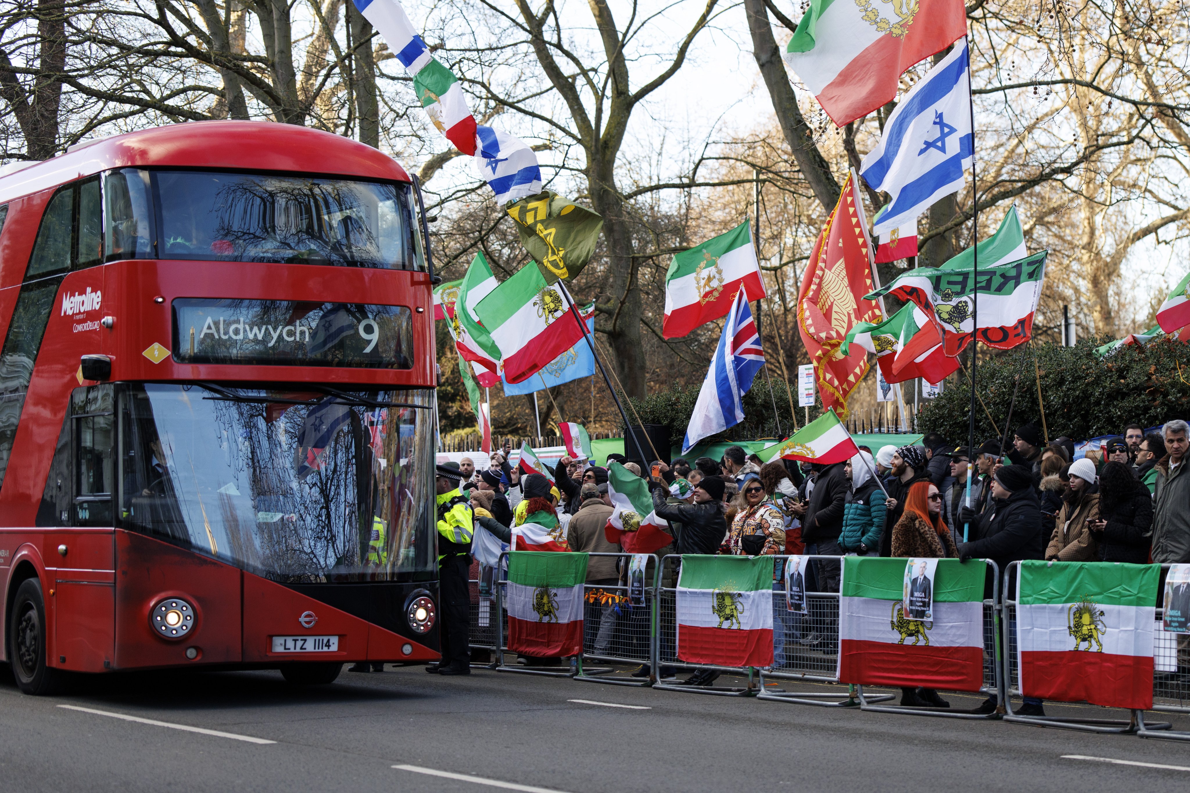 A bus drives past a protest by anti-government demonstrators and supporters of exiled Crown Prince of Iran, Reza Pahlavi, against the Iranian regime outside the embassy of Iran in London, Britain on Saturday. Photo: EPA
