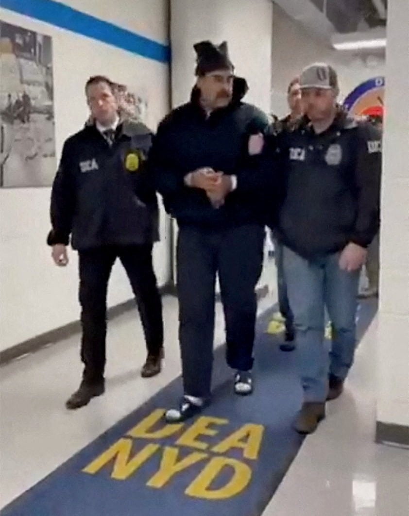 A still image from video posted on social media by a White House team shows Venezuelan President Nicolas Maduro being walked in the offices of the US Drug Enforcement Administration in New York. Photo: via Reuters