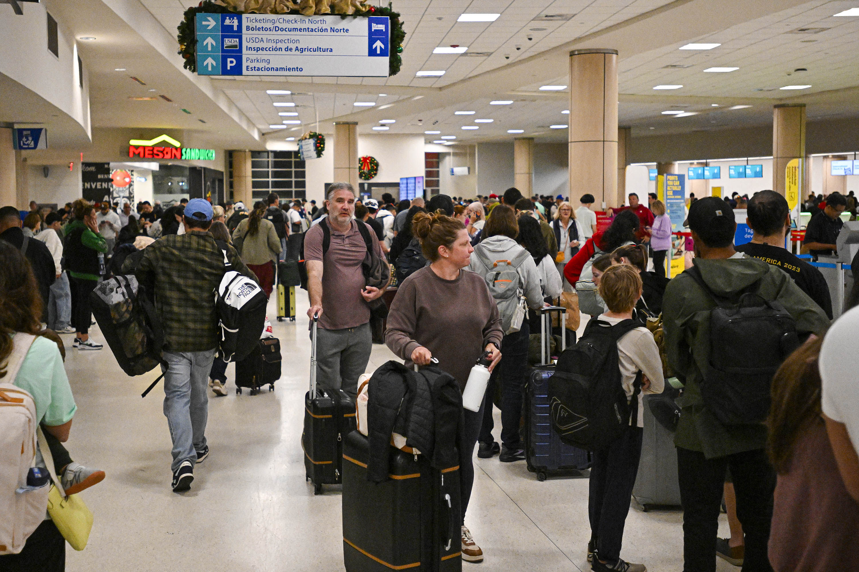 Passengers wait at the Luis Munoz Marin International Airport in Puerto Rico on Saturday. Photo: AFP