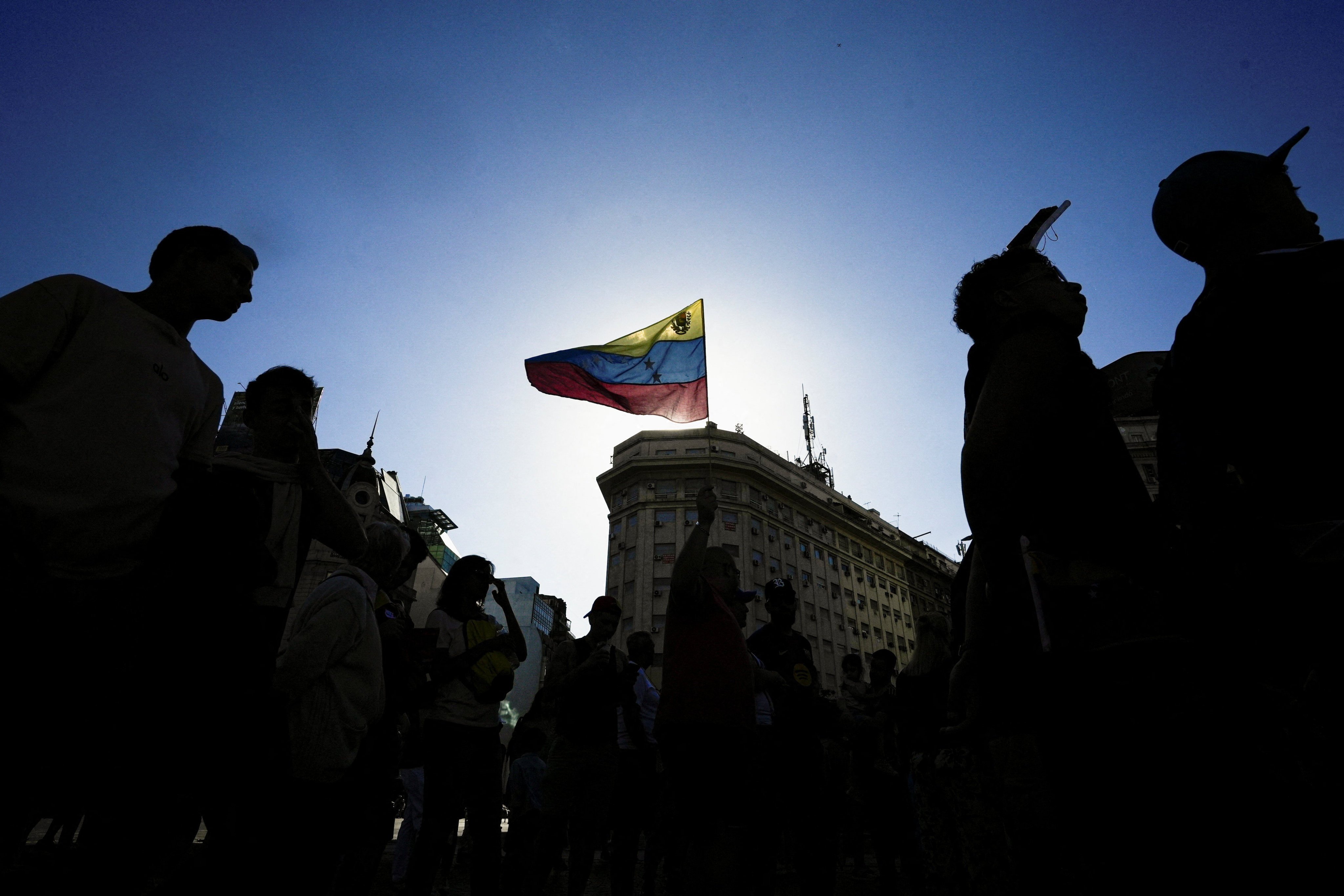 A Venezuelan flag is held up during a protest in Argentina calling for a democratic transition, after the US military strikes on fellow South American nation Venezuela. Photo: Reuters