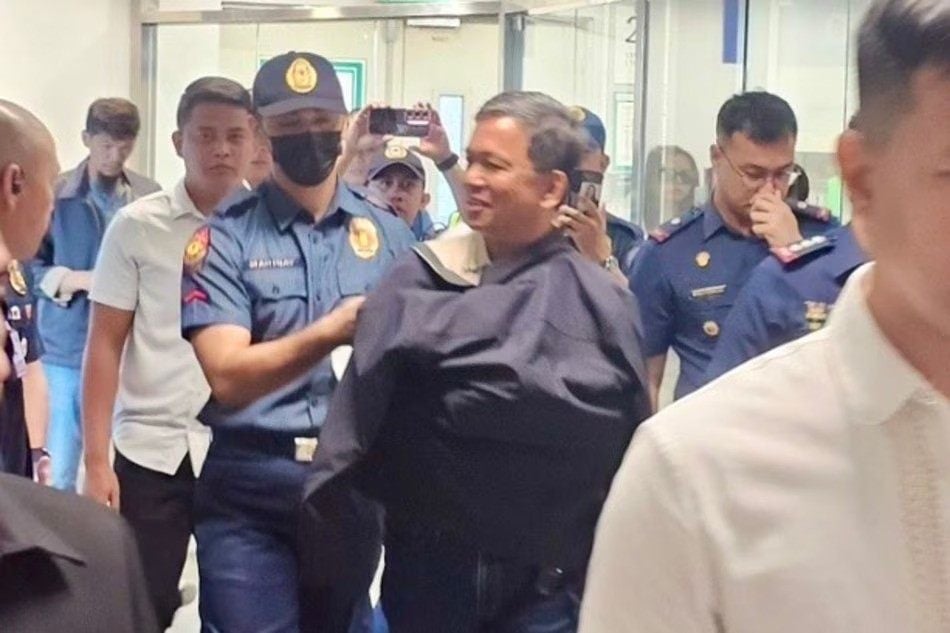 Romeo Poquiz (centre) is arrested on a sedition charge on Monday at Manila’s international airport. Photo: Philippine National Police

,