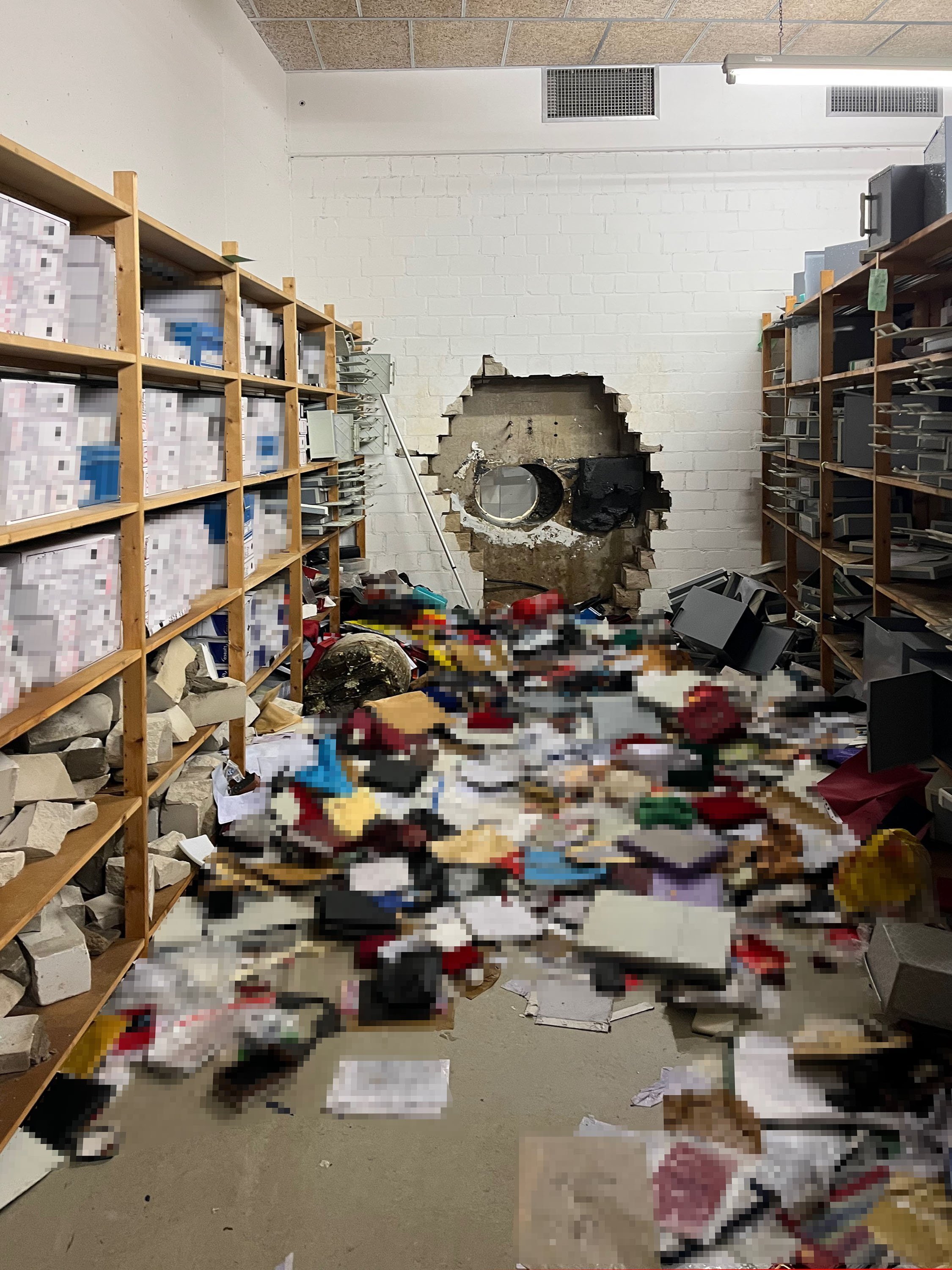 A giant hole in a wall of the vault of a Sparkasse bank branch after thieves broke in. Photo: Police Gelsenkirchen via EPA