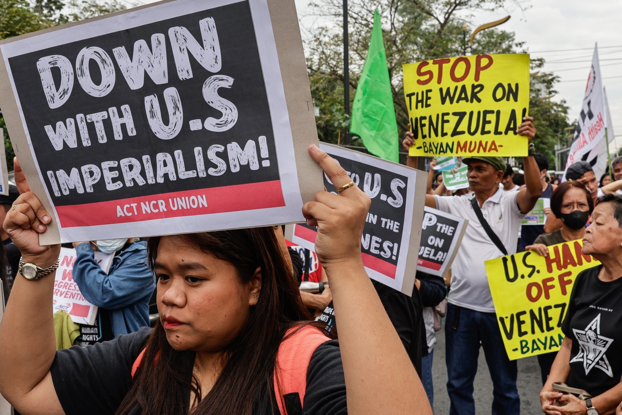 Protesters hold signs outside the US Embassy in Manila on Monday during a rally opposing Washington’s military action in Venezuela following the seizure of President Nicolas Maduro. Photo: EPA-EFE