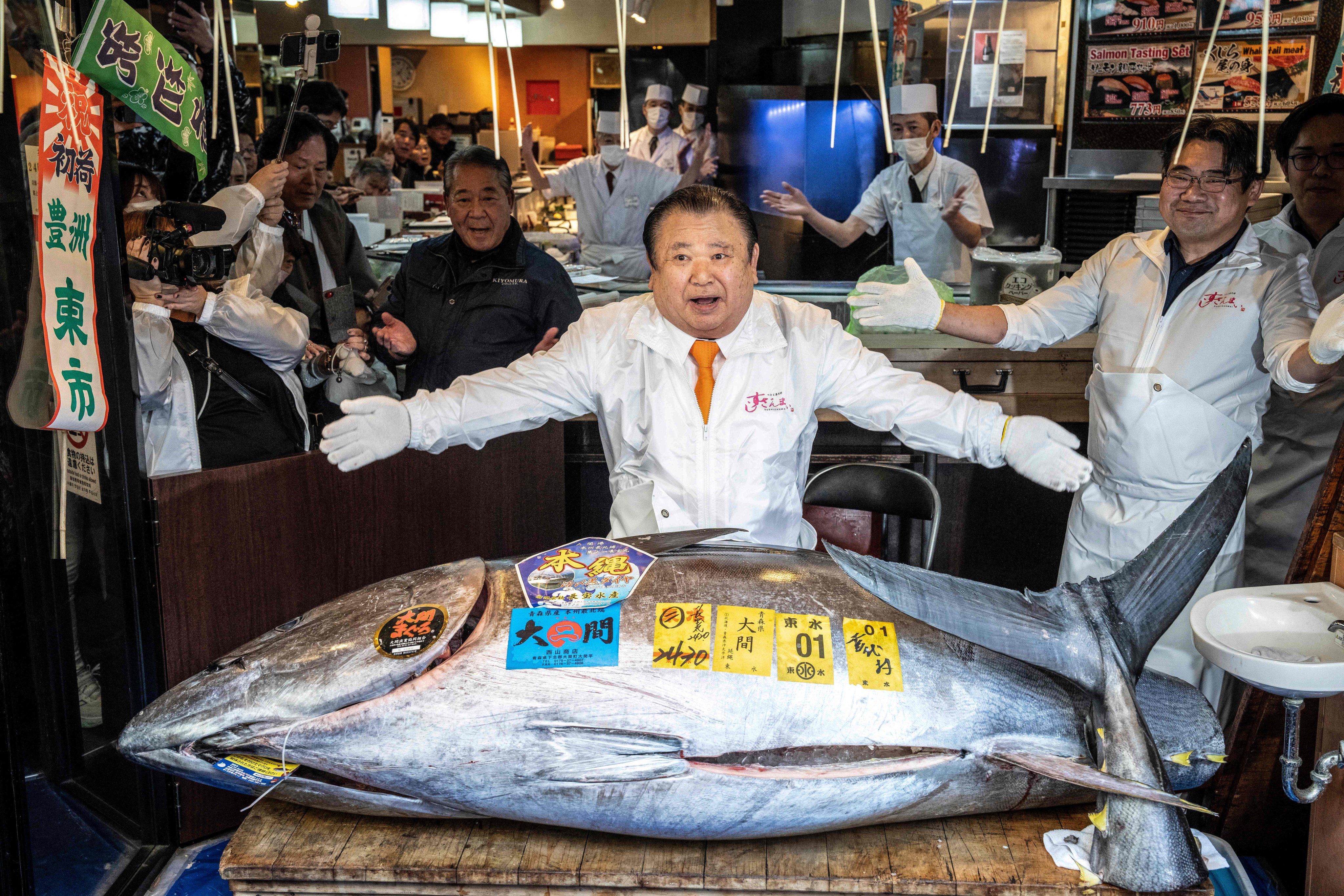 Kiyoshi Kimura displays the 243kg bluefin tuna he bought at his main restaurant in Tokyo on Monday. Photo: AFP