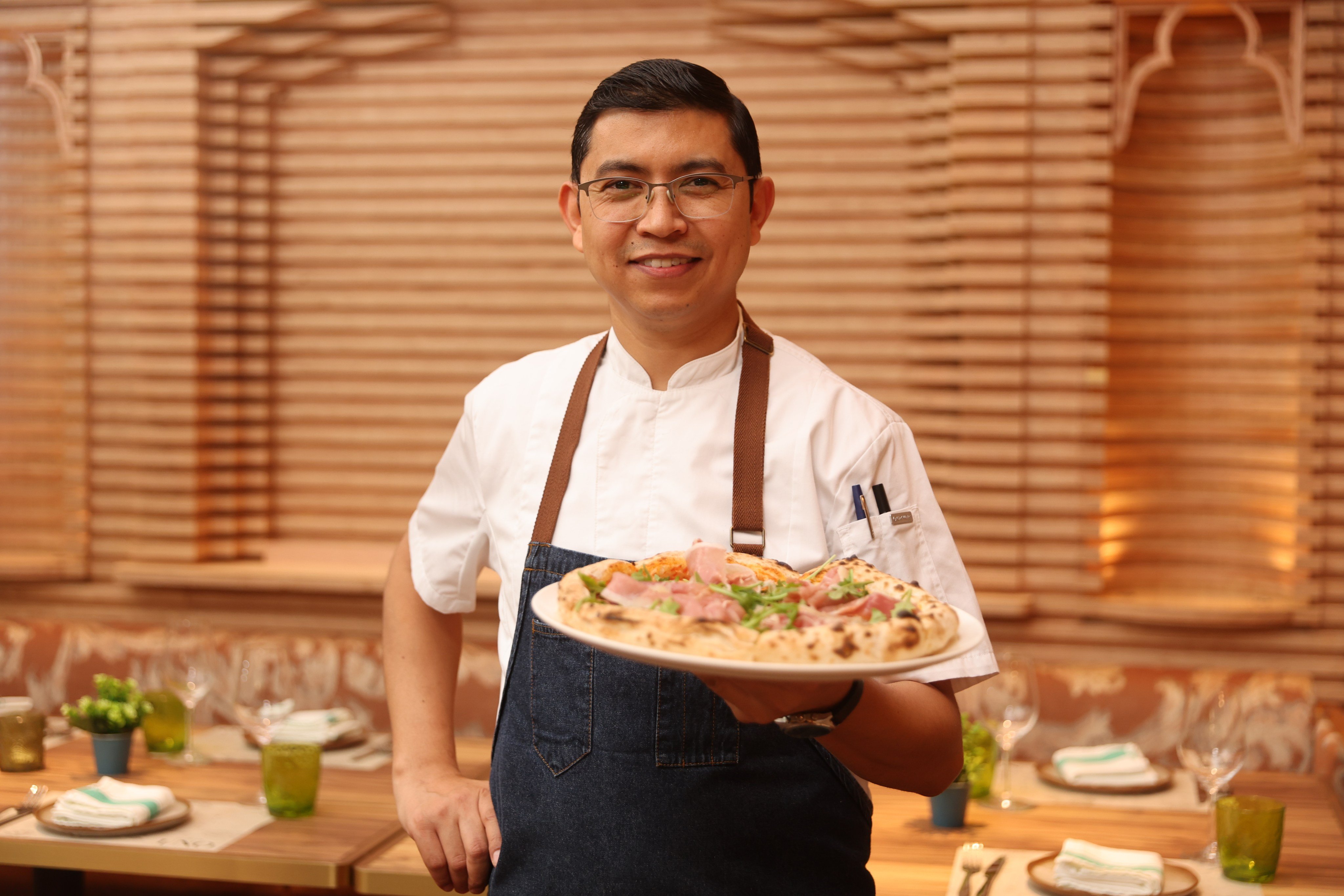 Osteria Uno head chef Bhupendra Singh presents a pizza at the restaurant in Tai Kok Tsui, Hong Kong. Photo: Edmond So