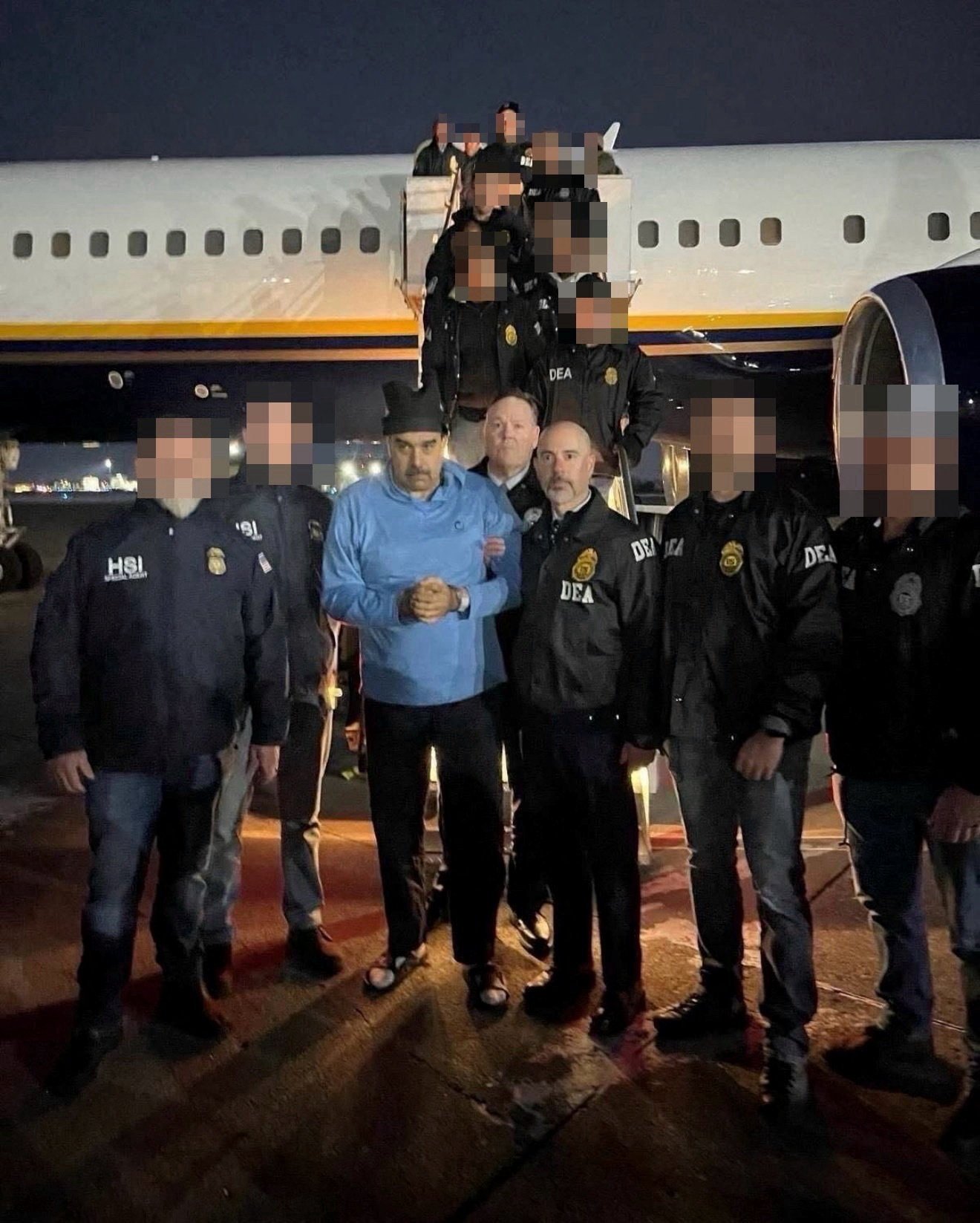Venezuela’s captured President Nicolas Maduro poses next to US Drug Enforcement Administration (DEA) administrator Terry Cole as he is led in custody from a US federal airplane, at Stewart Air National Guard Base in Newburgh, New York, on January 3, 2026. Photo: Handout via Reuters