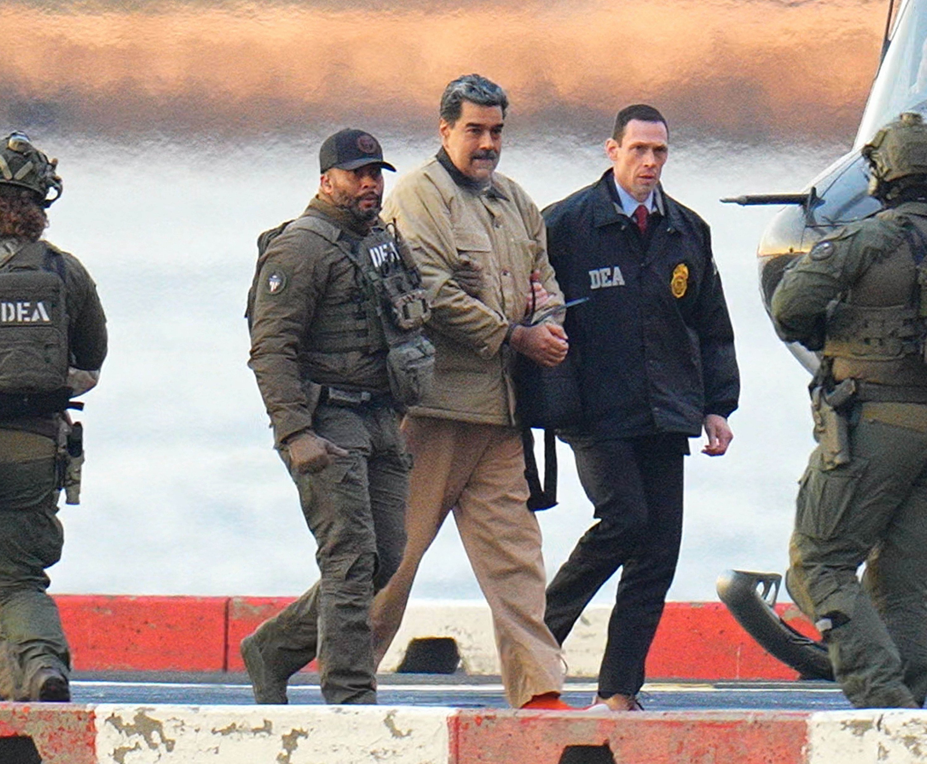 Venezuelan leader Nicolas Maduro in handcuffs after landing at a helipad in New York, escorted by US federal agents on Monday. Photo: TNS