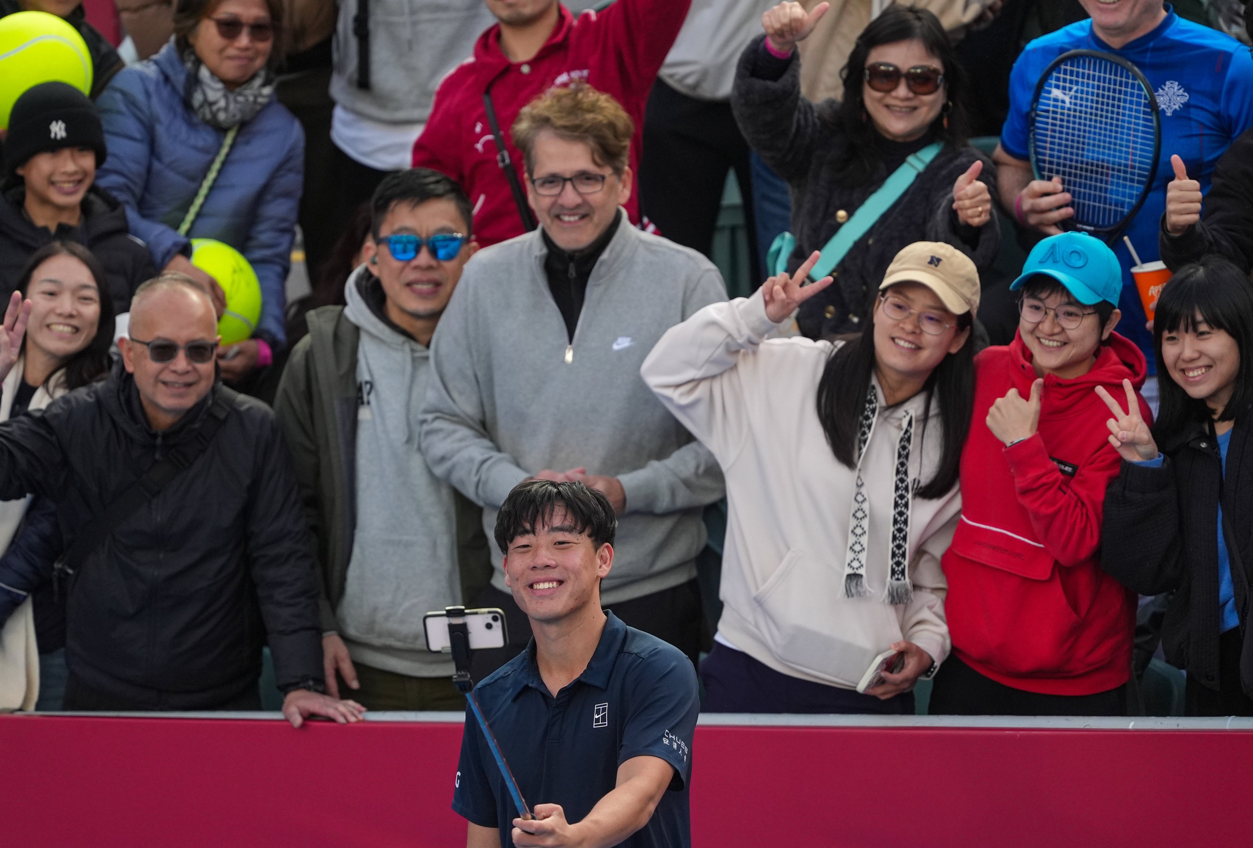 Coleman Wong taking selfies with supporters after winning his first-round match at the Hong Kong Open on Tuesday. Photo: Elson Li