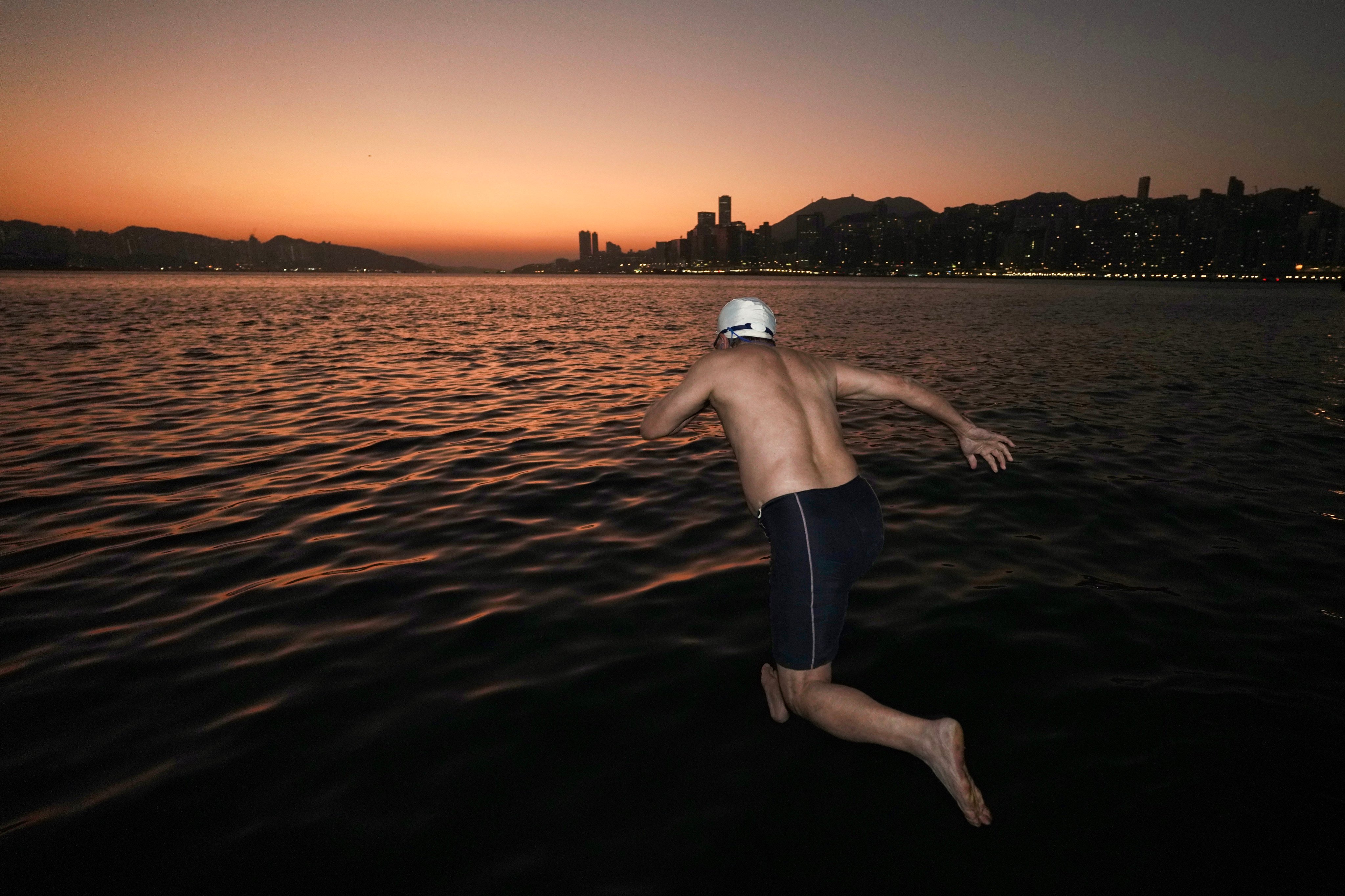 A resident goes for a swim in waters off Hung Hom Promenade in Kowloon, despite the cold weather on Wednesday. Photo: Karma Lo