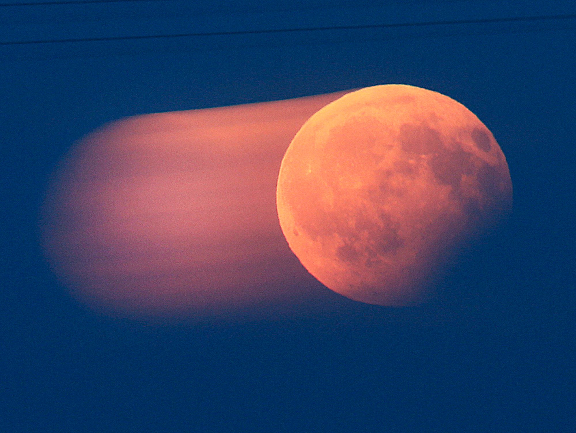 This photo taken with a long exposure time shows the rising full moon during a partial lunar eclipse. Photo: AP