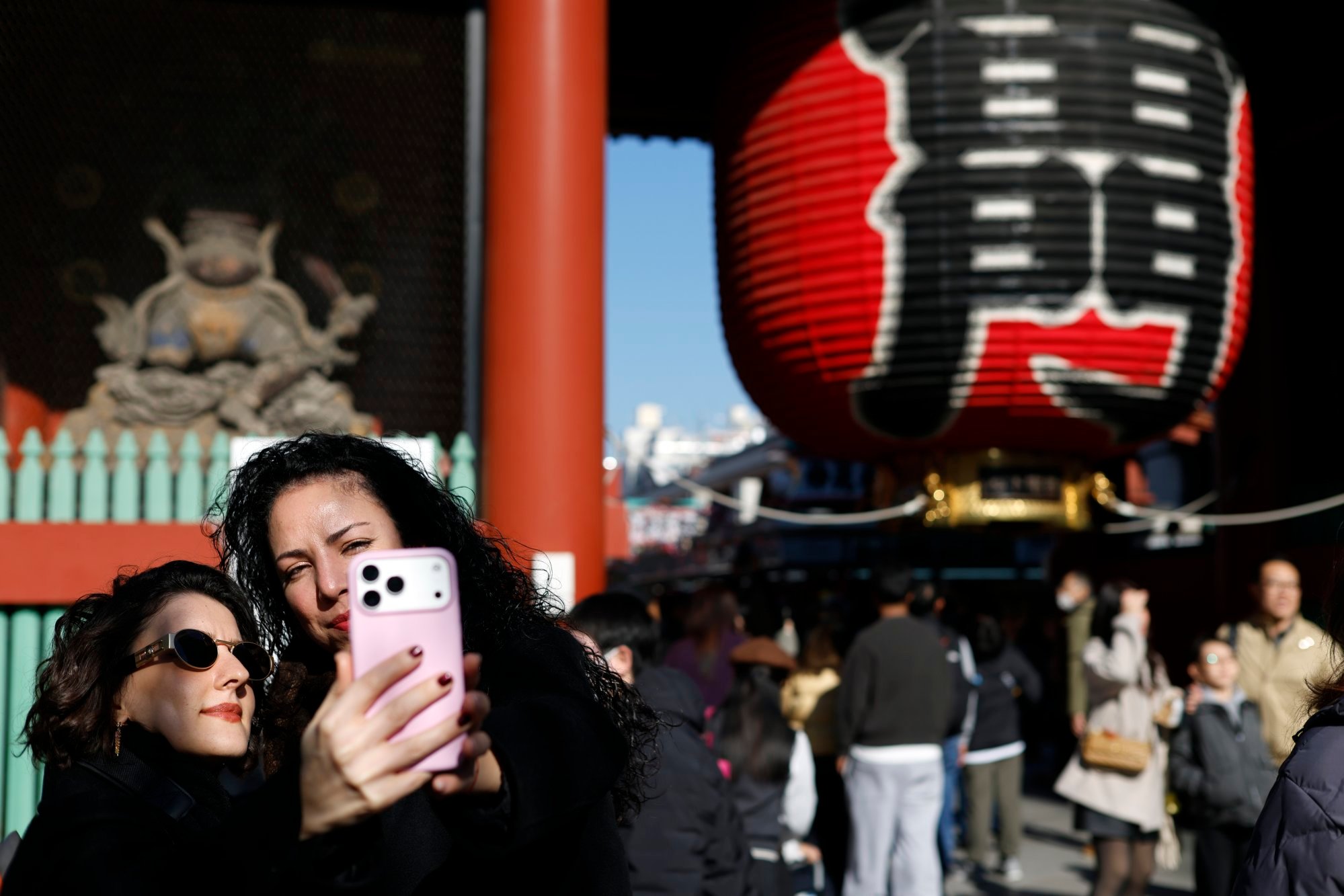 Tourists take a selfie in front of the Kaminarimon gate in Tokyo’s Asakusa district. Photo: EPA