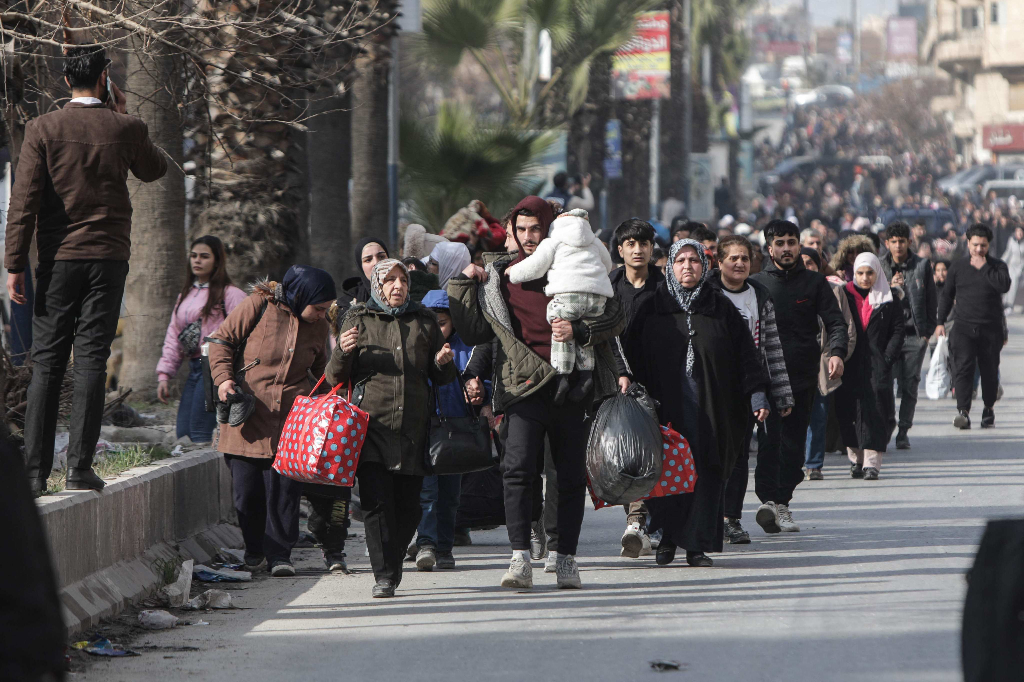 People flee Aleppo’s Ashrafiyah Kurdish neighbourhood on Wednesday. Photo: AFP