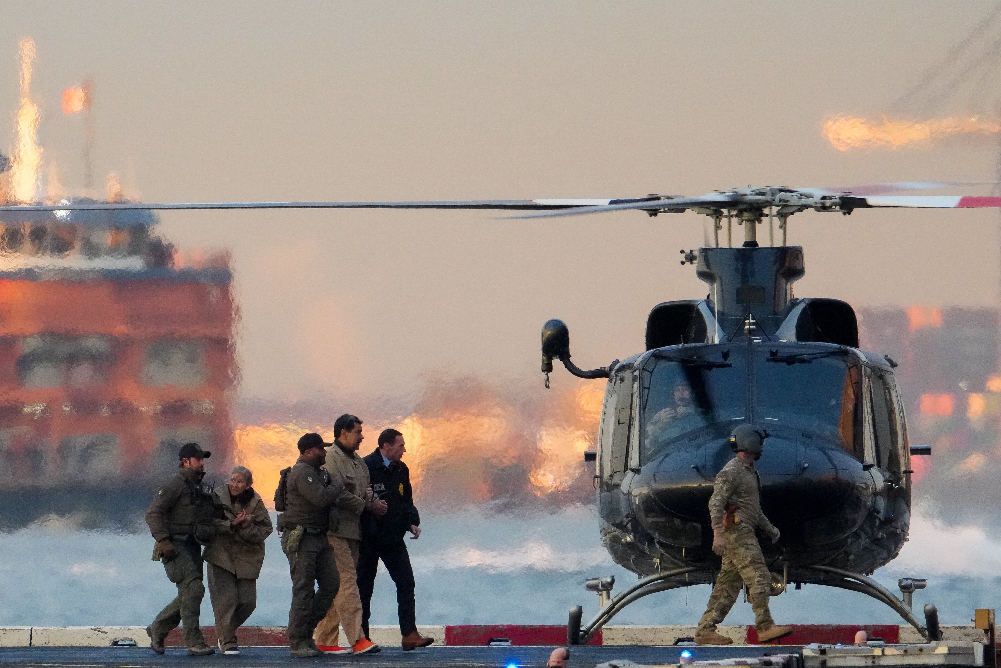 US Drug Enforcement Administration agents move captured Venezuelan President Nicolas Maduro and his wife Cilia Flores out of a helicopter in New York City, on January 5. Photo: Reuters
