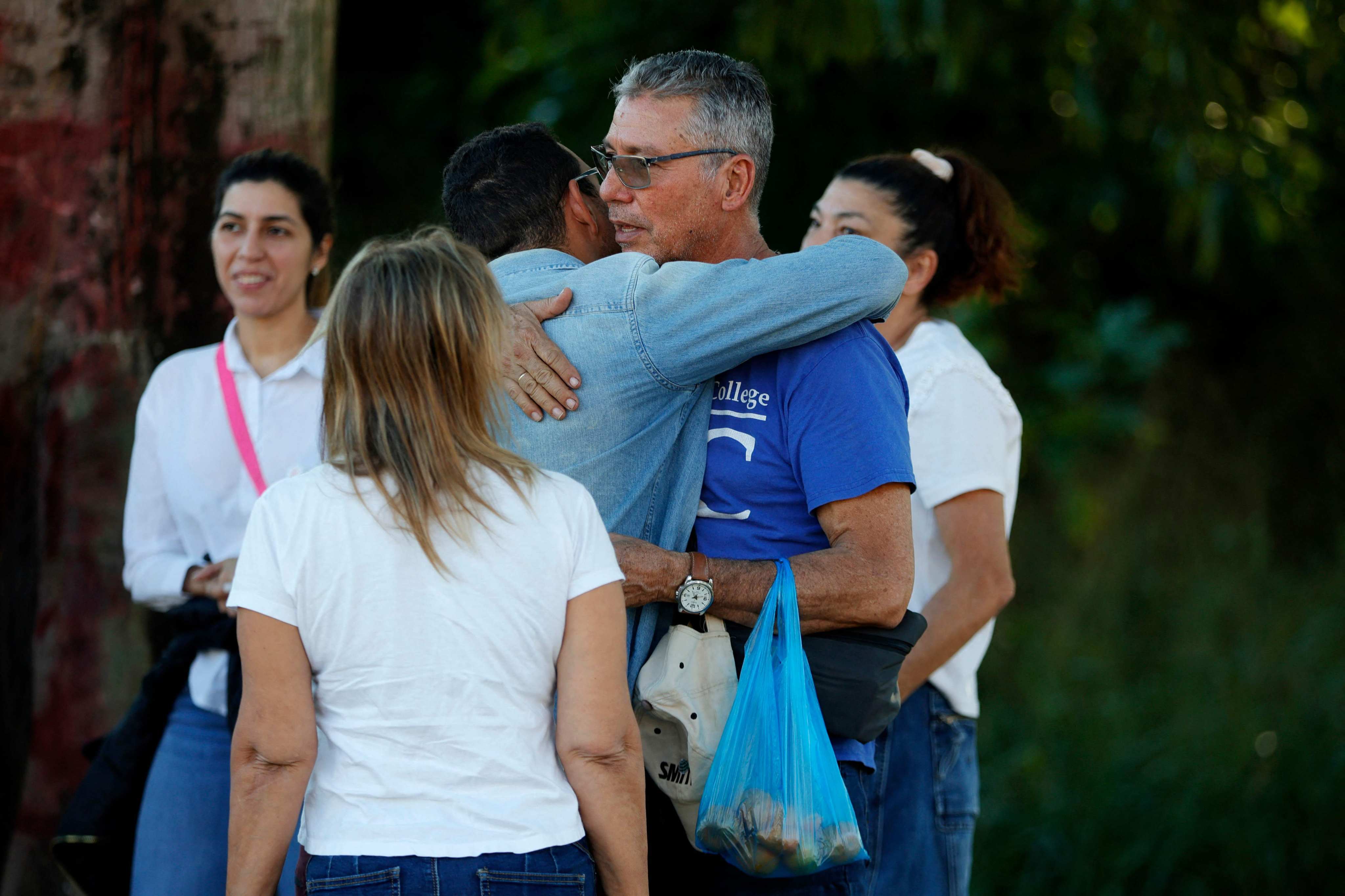 Relatives of prisoners hug each other as they wait in front of El Rodeo jail in Caracas on Thursday. Photo: AFP