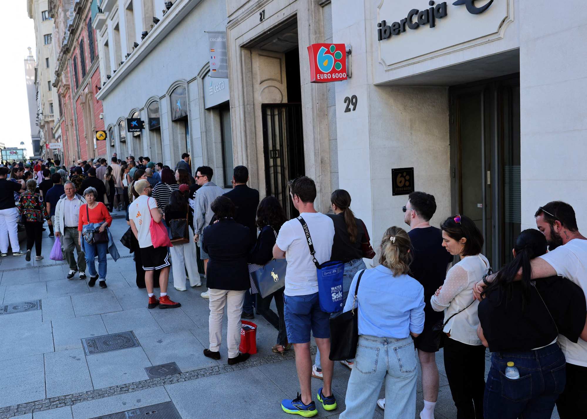 People queue to withdraw cash at an ATM as credit card payments were unavailable due to a massive power outage in Madrid in April 2025. It cut mobile phone and internet networks, halted trains and trapped people in lifts, officials said. Photo: AFP People queue to withdraw cash at an ATM as credit card payments were unavailable due to a massive power outage in Madrid in April 2025. It cut mobile phone and internet networks, halted trains and trapped people in lifts, officials said. Photo: AFP