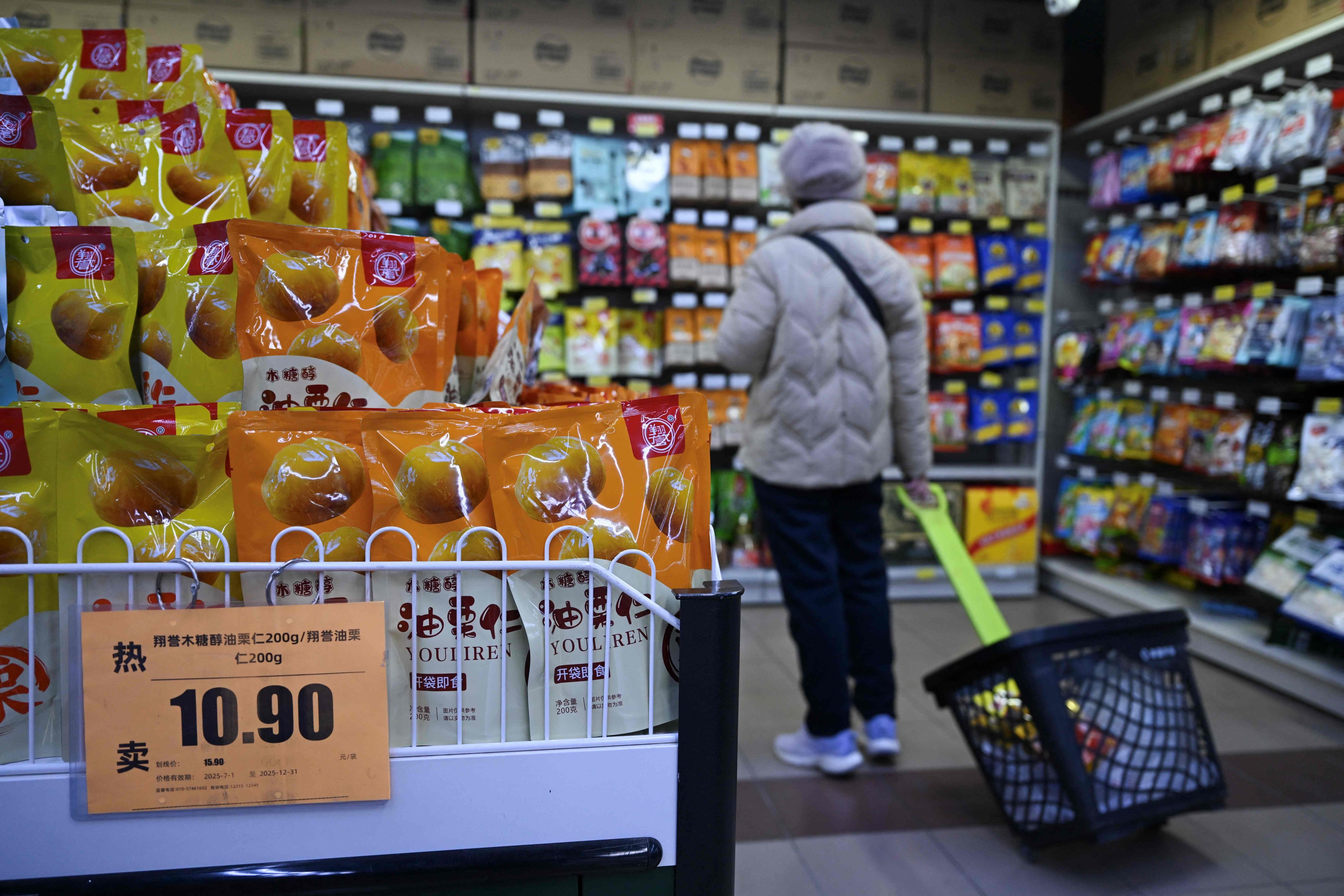 A shopper browses shelves at a supermarket in Beijing. China’s consumer prices stayed flat in 2025, official data showed. Photo: AFP