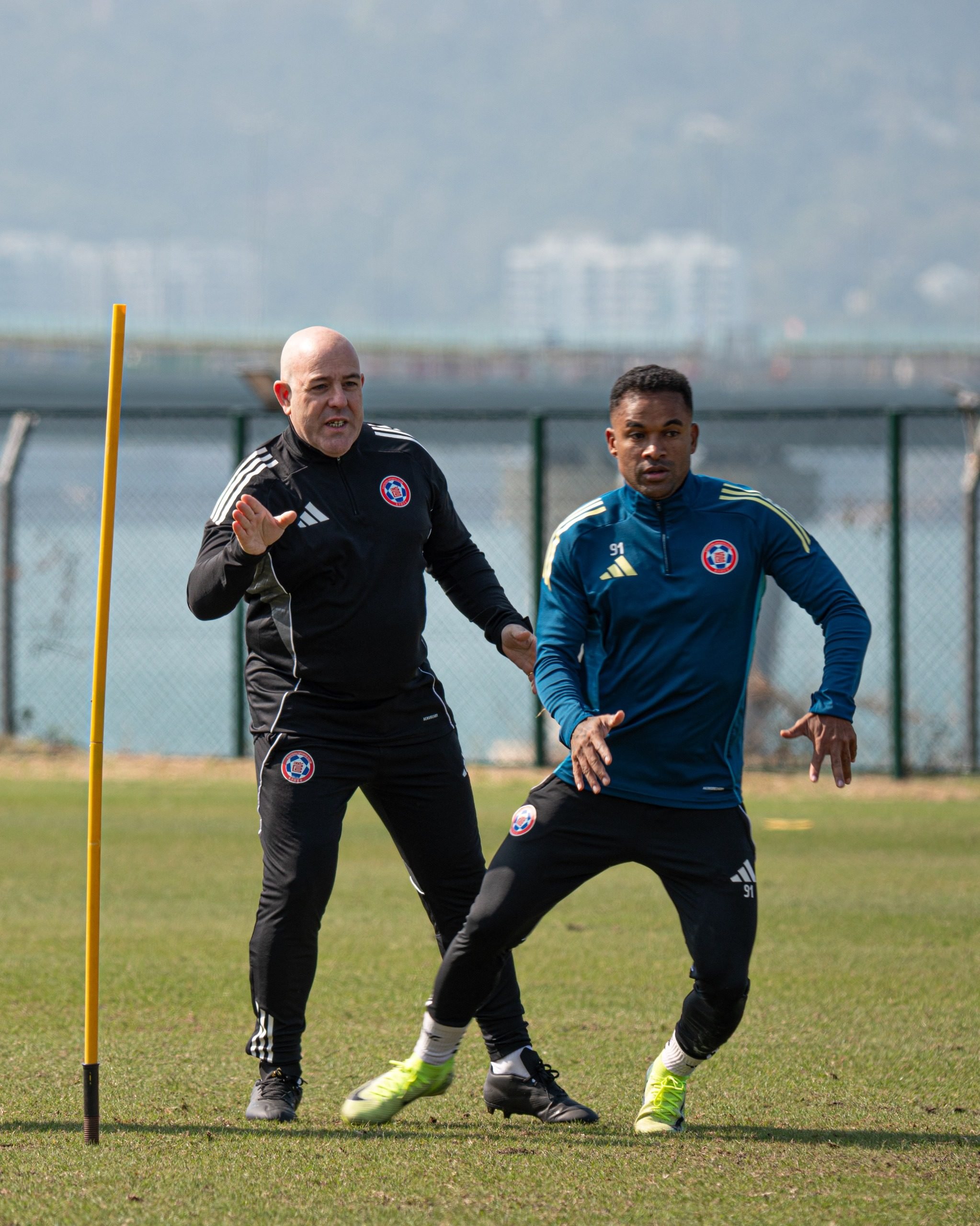 Manu Torres (left) issues instructions to winger Gil Martins as he gets to know the Eastern players during a  training session in Tseung Kwan O. Photo: Eastern SC.