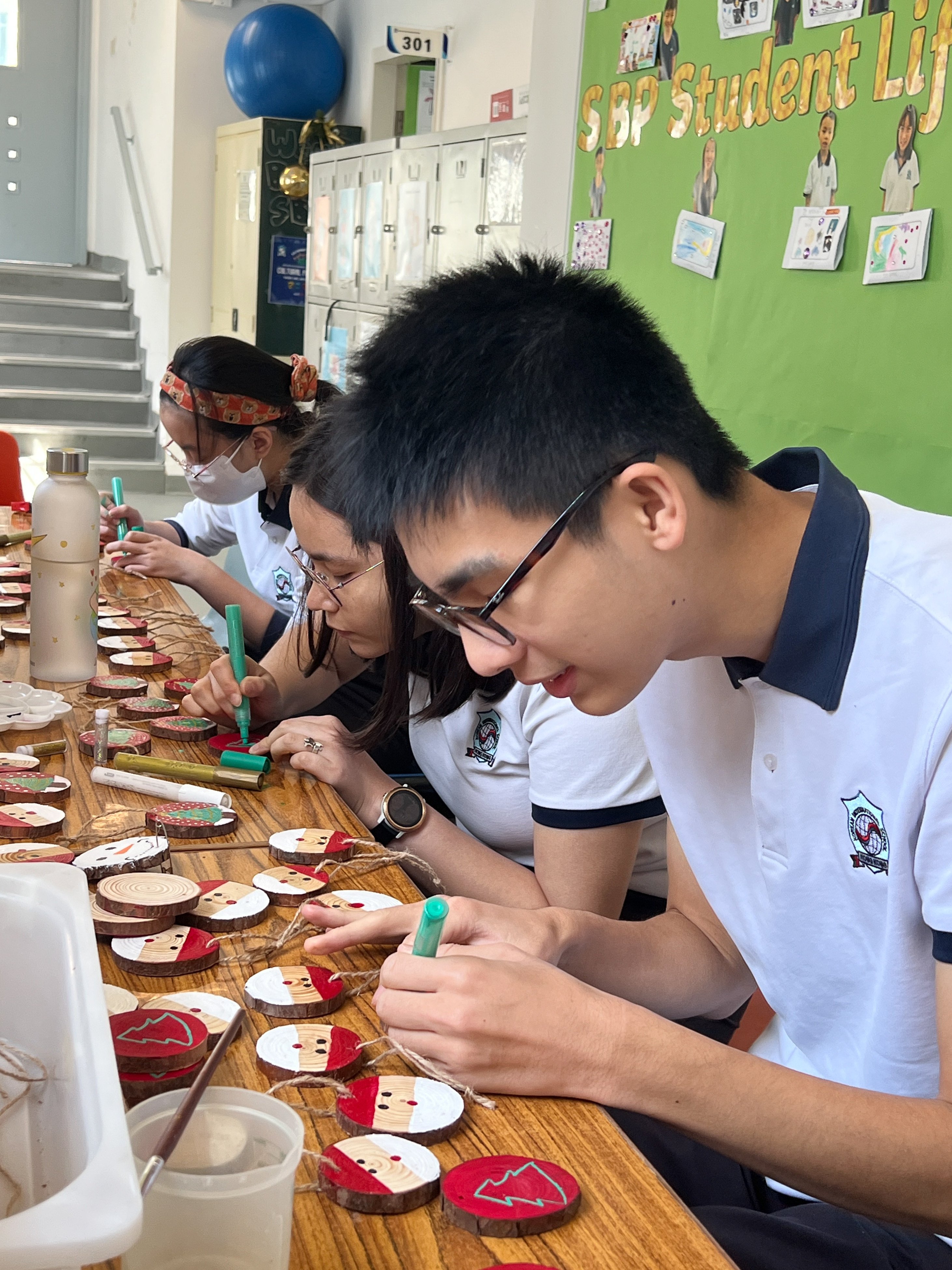 Korean International School students craft Christmas decorations for their school’s charity sale. Photo: Handout