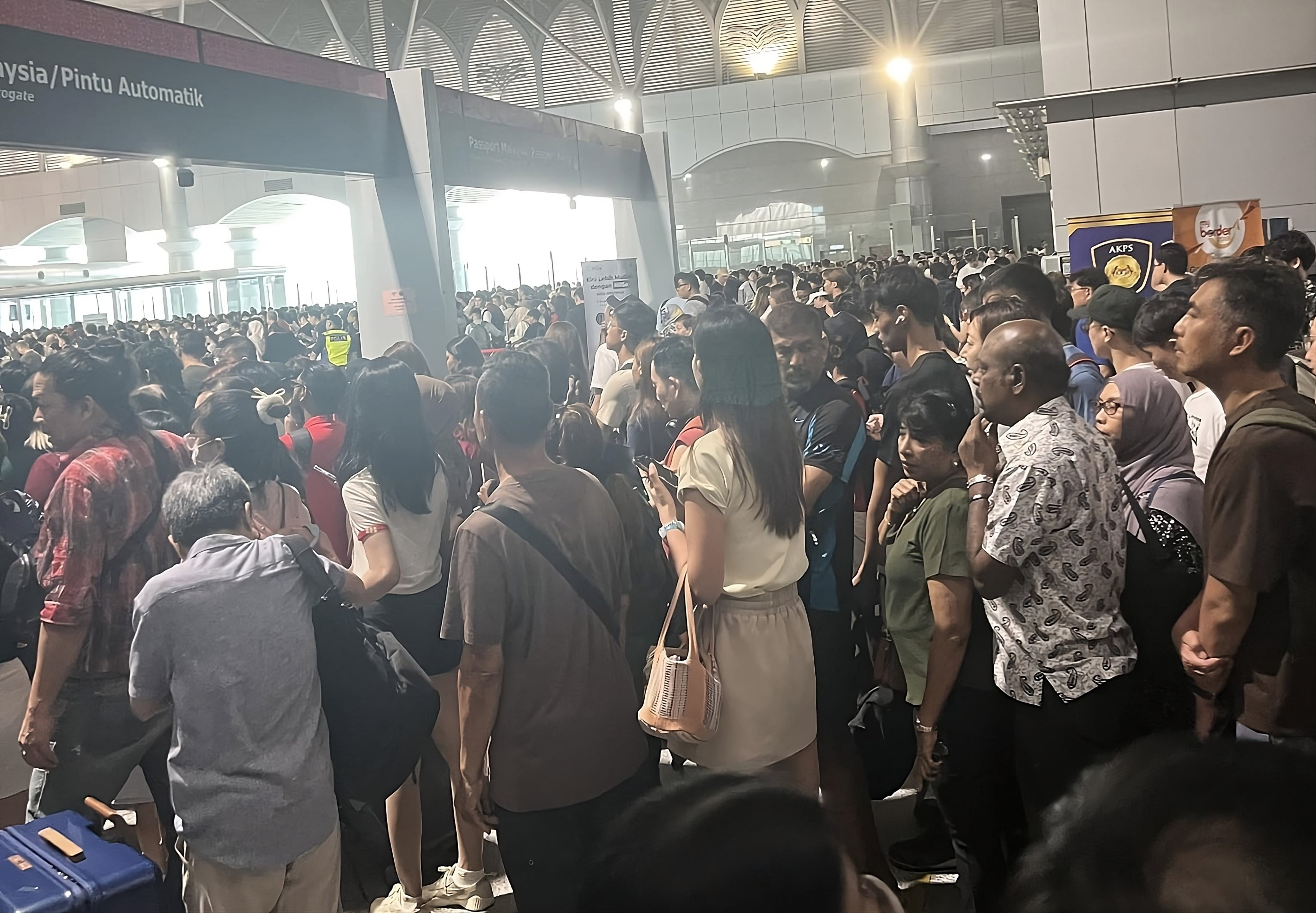 An image circulated on social media on Saturday shows a crowd of travellers waiting to pass through automated immigration gates at the Malaysia-Singapore border. Photo: Facebook