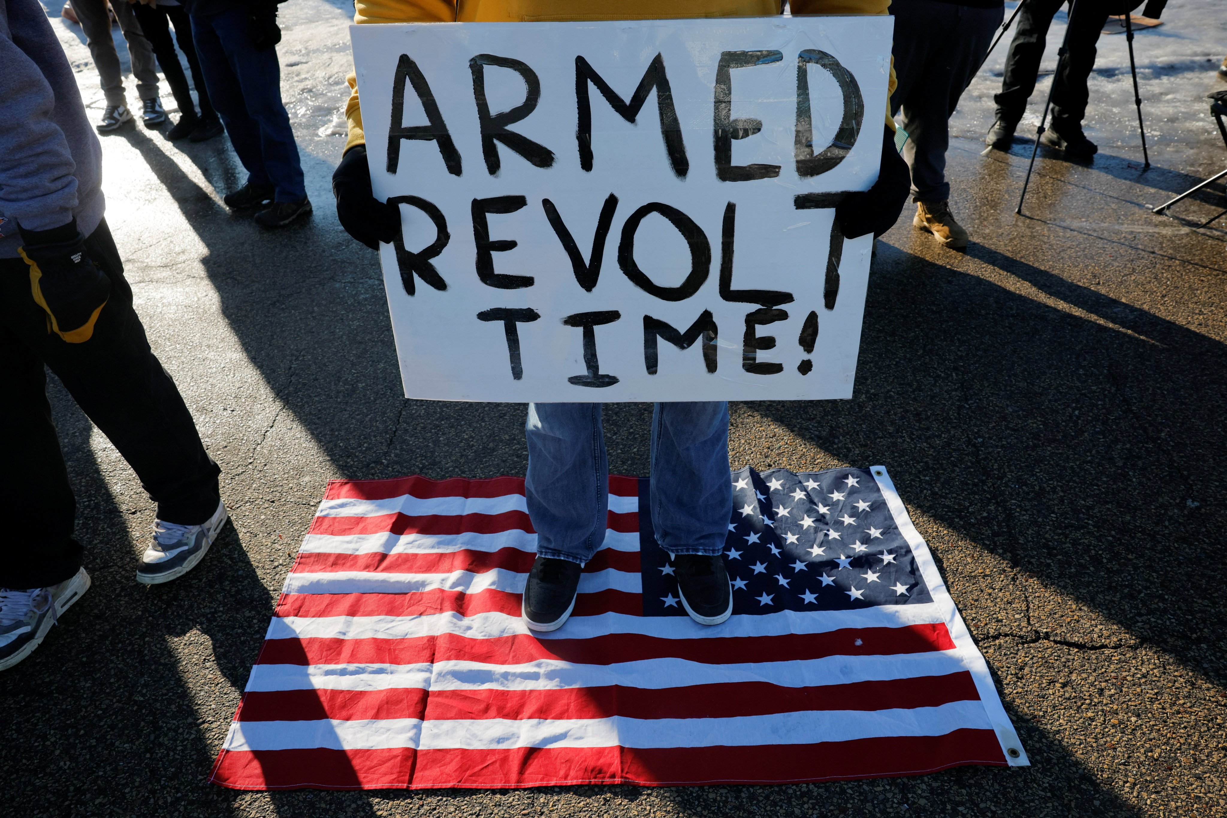 A person holds a sign as people protest against increased immigration enforcement, after the ICE shooting of Renee Nicole Good, in Minneapolis, Minnesota, on Friday . Photo: Reuters