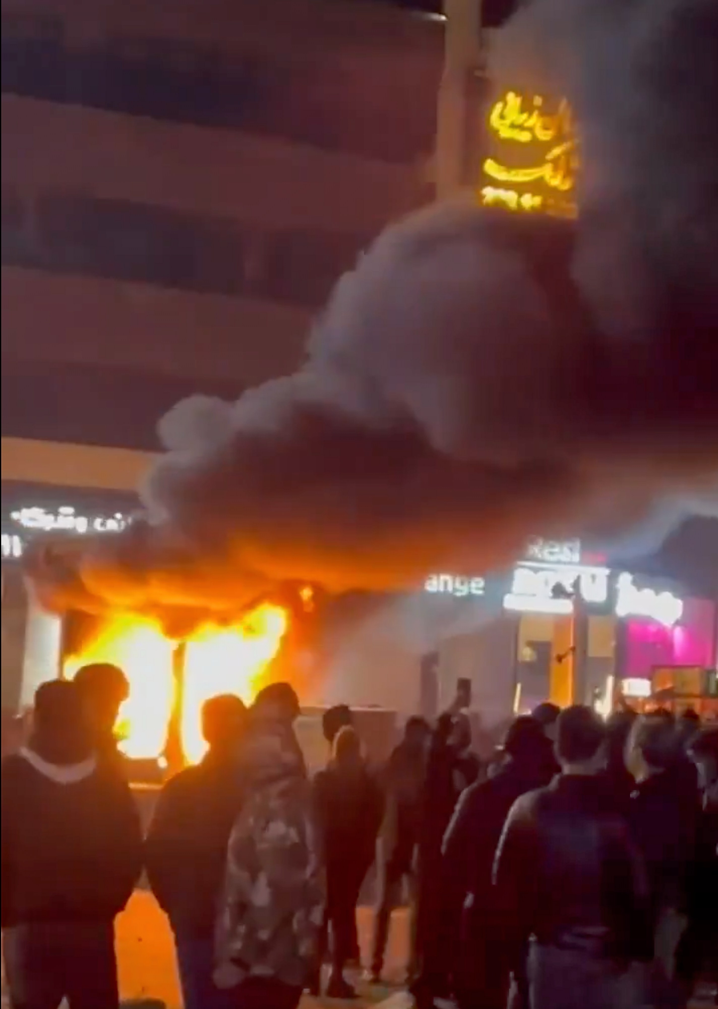 A frame grab from video shows a fire as people protest in Tehran, Iran, on Friday. Photo: UGC via AP