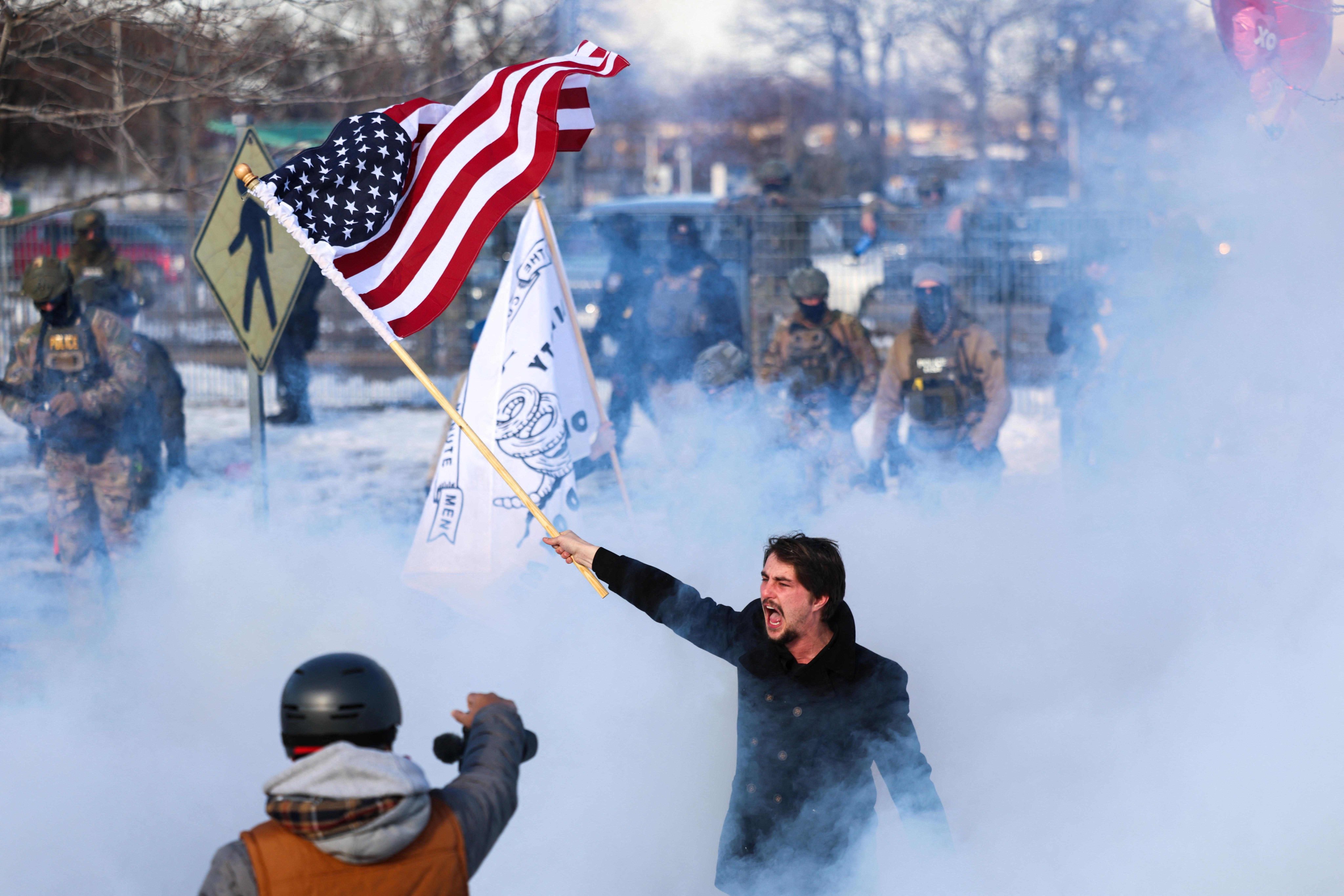 A man waves a US flag at an anti-ICE protest in Minneapolis, Minnesota, on Friday. Photo: AFP