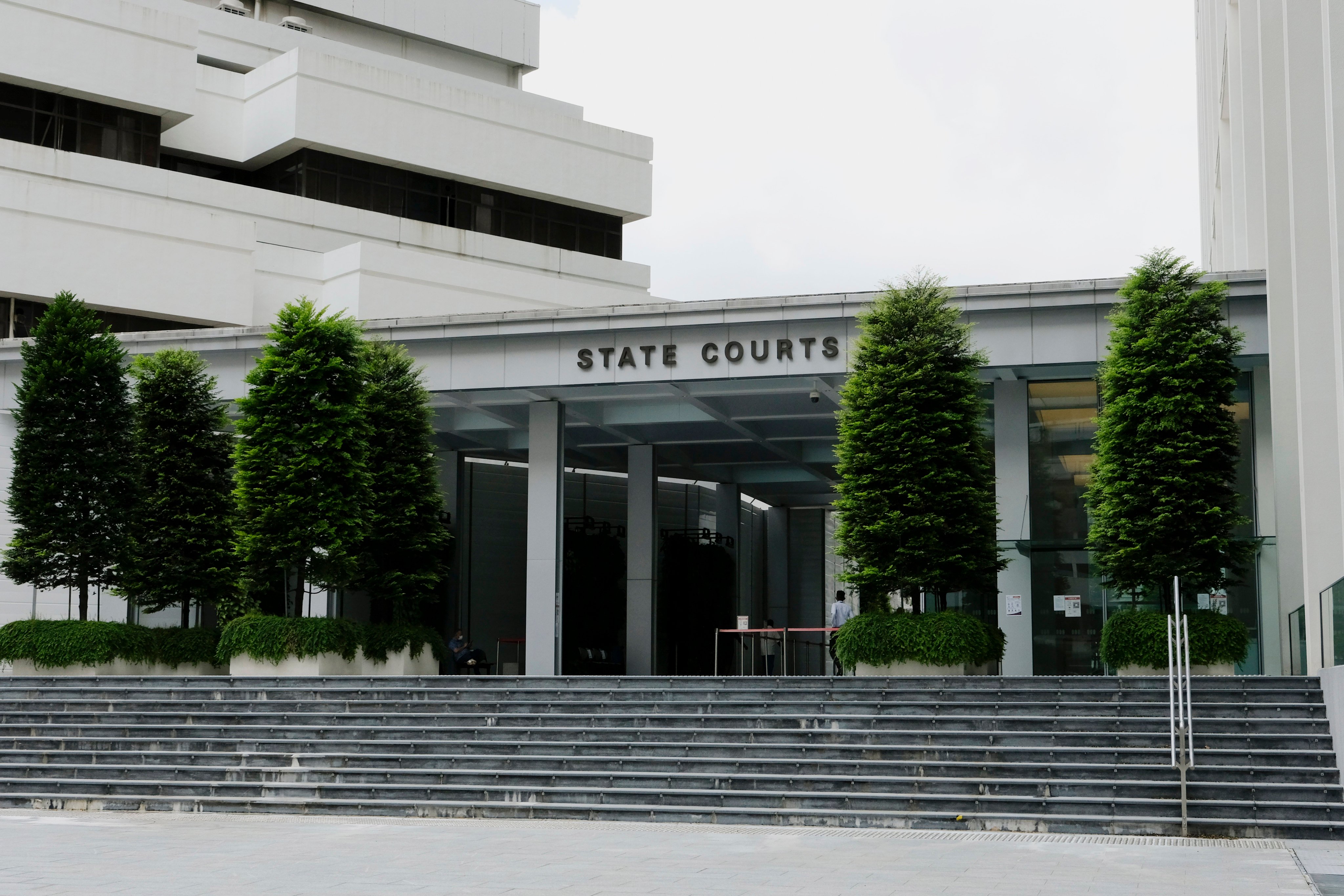 People enter the Singapore’s State Courts. Photo: AP
