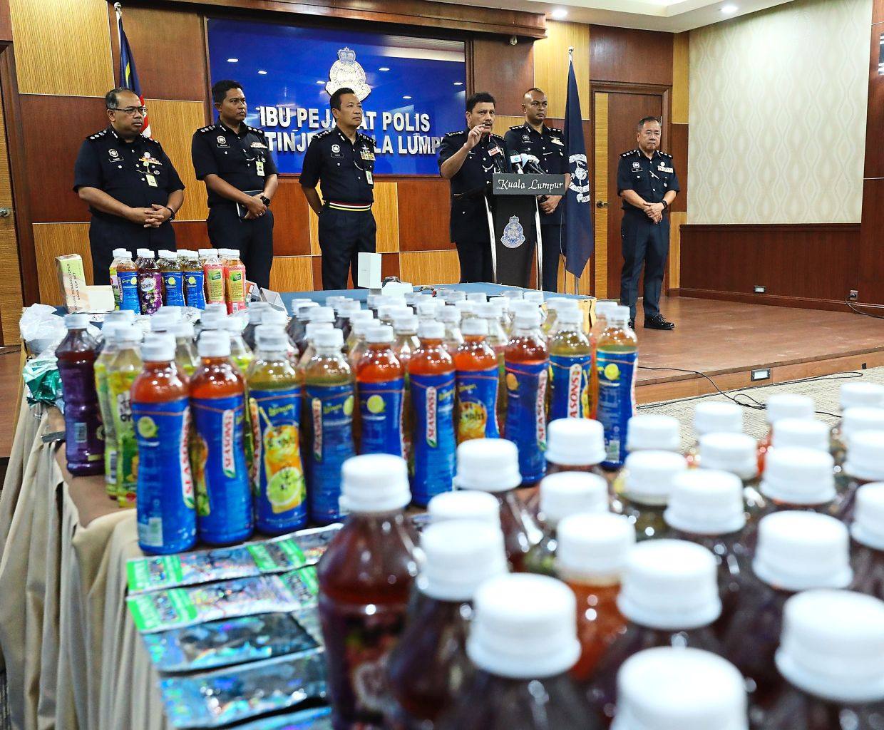 KL police display drug laced drinks seized in a 2023 raid. Photo: The Star