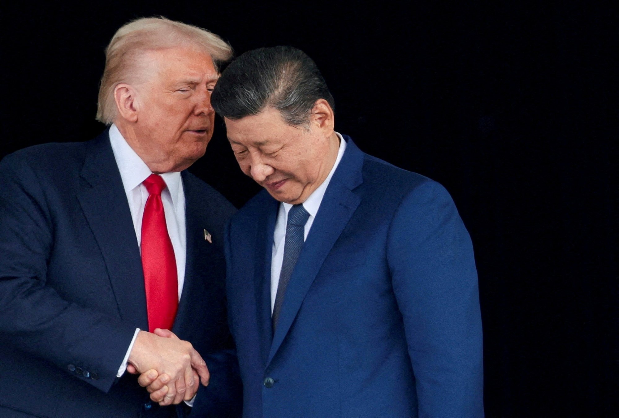 US President Donald Trump and Chinese President Xi Jinping talk as they leave after a bilateral meeting in South Korea last year. Photo: Reuters