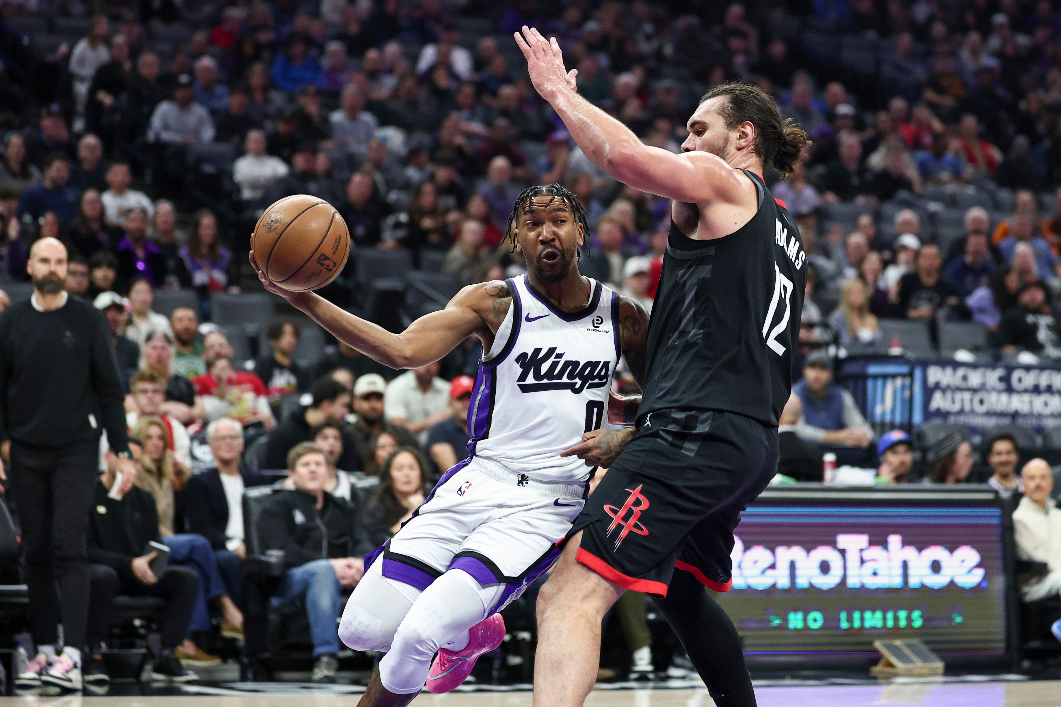 Sacramento Kings guard Malik Monk (left) looks to pass around Houston Rockets centre Steven Adams during their NBA encounter on Sunday. Photo: AP