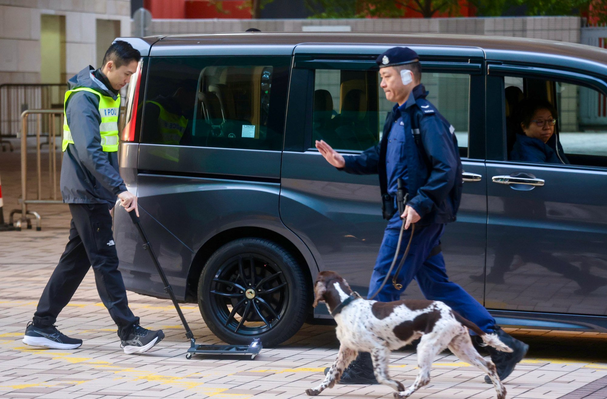 Police search vehicles passing through Tung Chau Street outside West Kowloon Court. Photo: Jonathan Wong