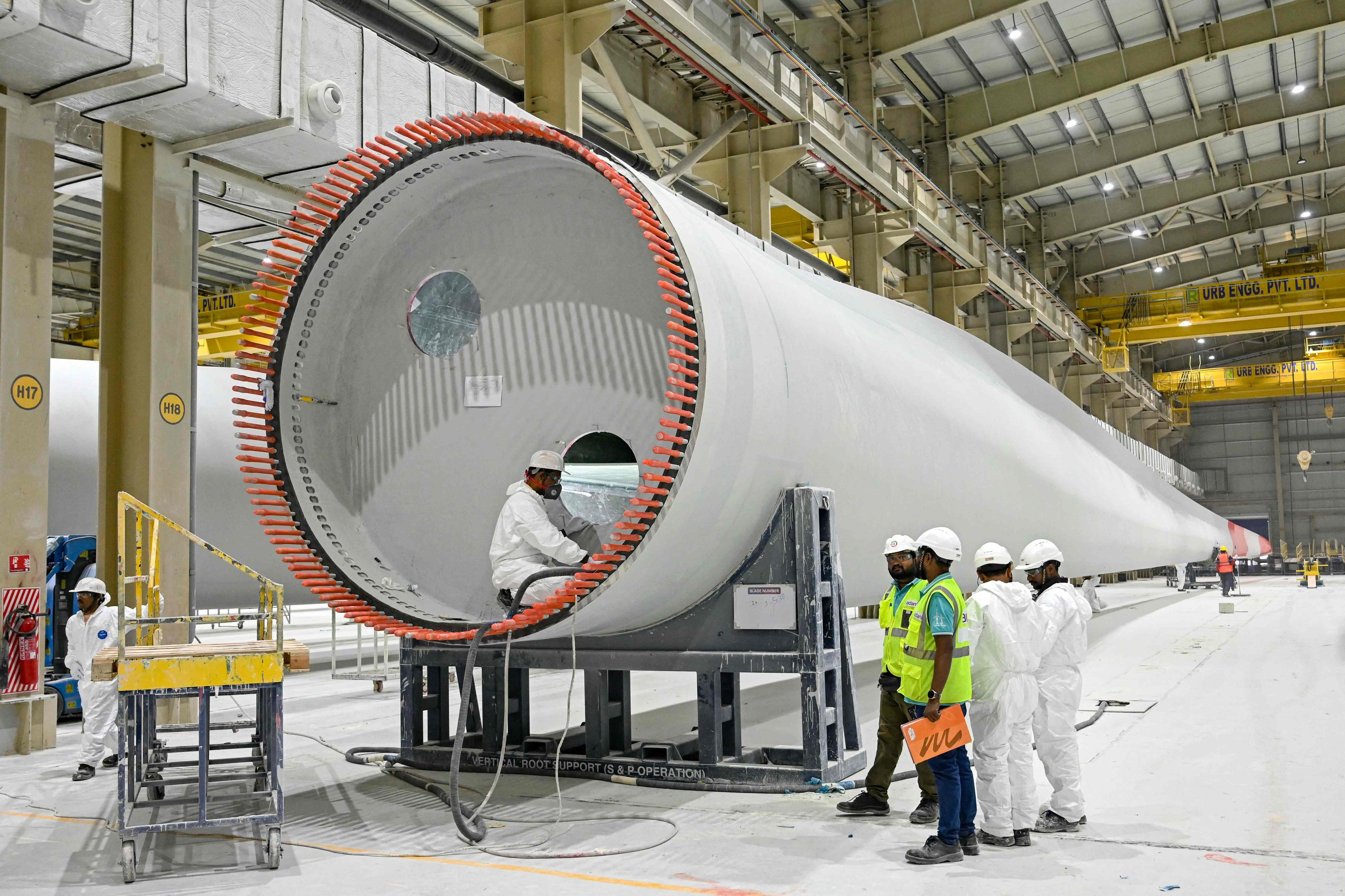 Employees work on a wind turbine blade at an Adani Group factory in Mundra, India. Photo: AFP
