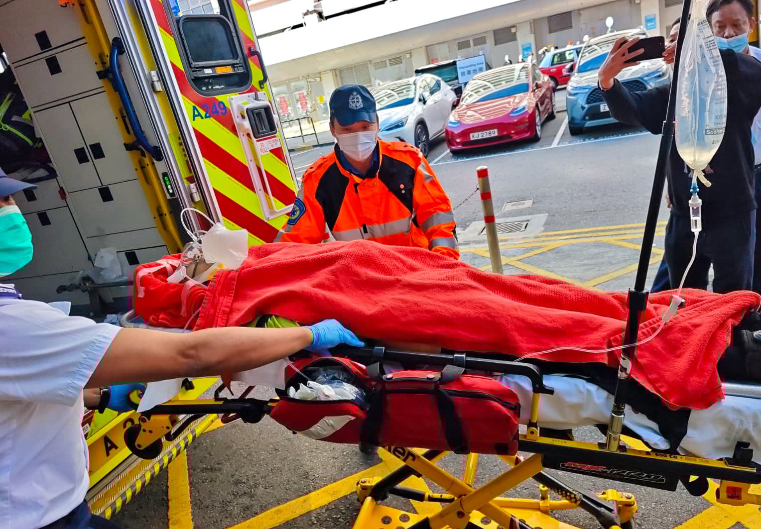 One of the injured workers is wheeled into an ambulance after being struck by gas cylinders at the Po Fung Road construction site. Photo: Handout