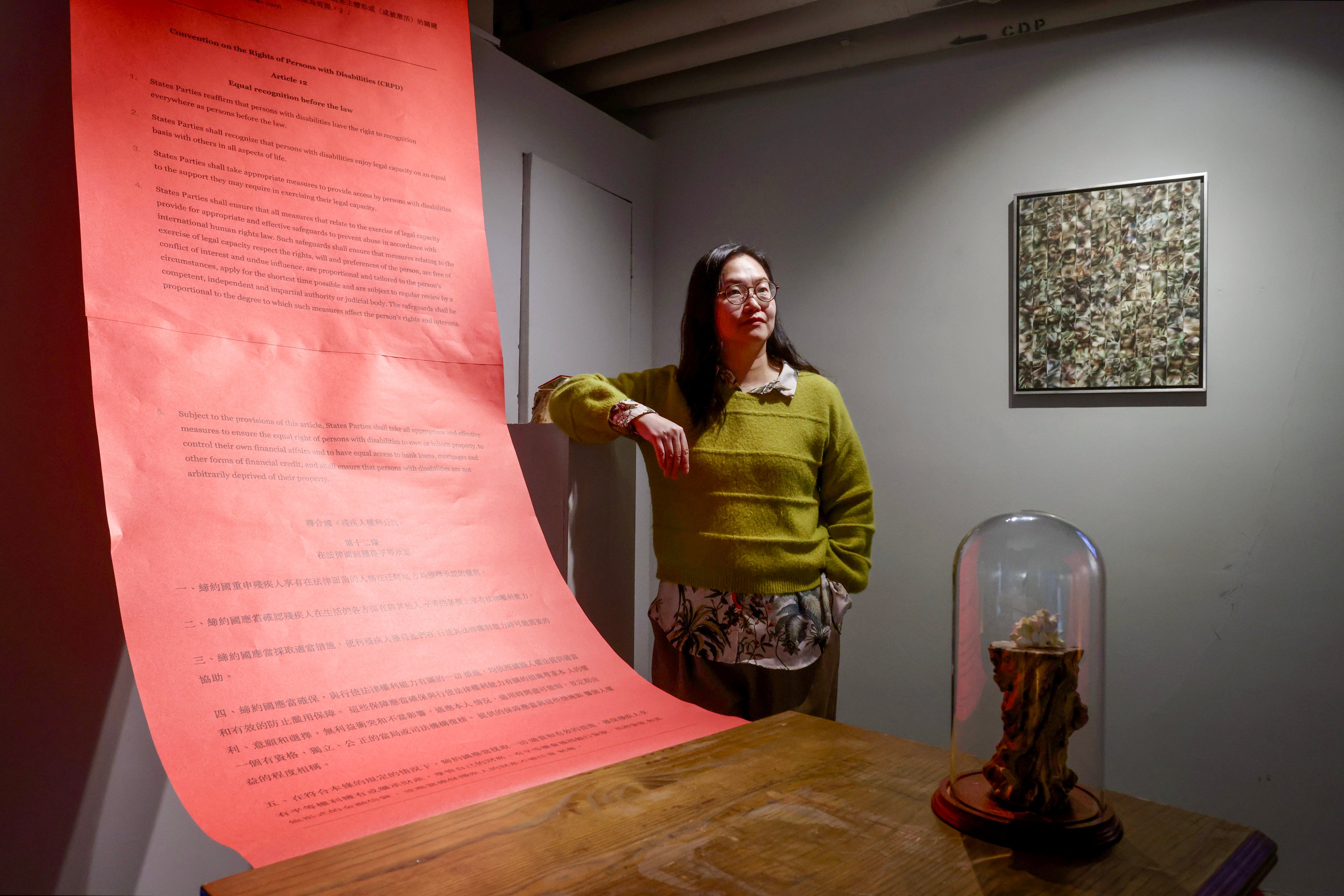 Sophie Cheung poses among works at her “Decolonising Madness: The Naturally (In)complete Human” exhibition, which runs at Eaton HK until February 1. Photo: Jonathan Wong
