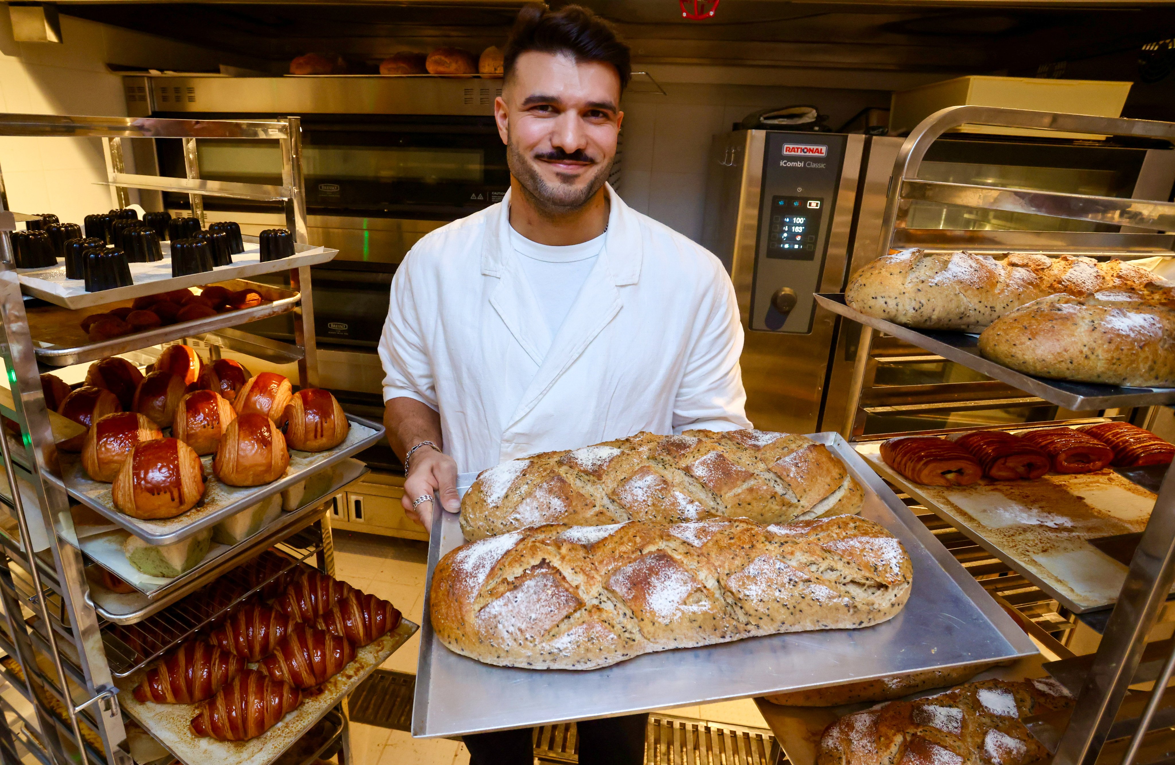 Social Goods founder Chris Younes holds a tray of sourdough loaves at the new bakery and cafe in Central, Hong Kong Island, on January 8, 2026. Photo: Jonathan Wong