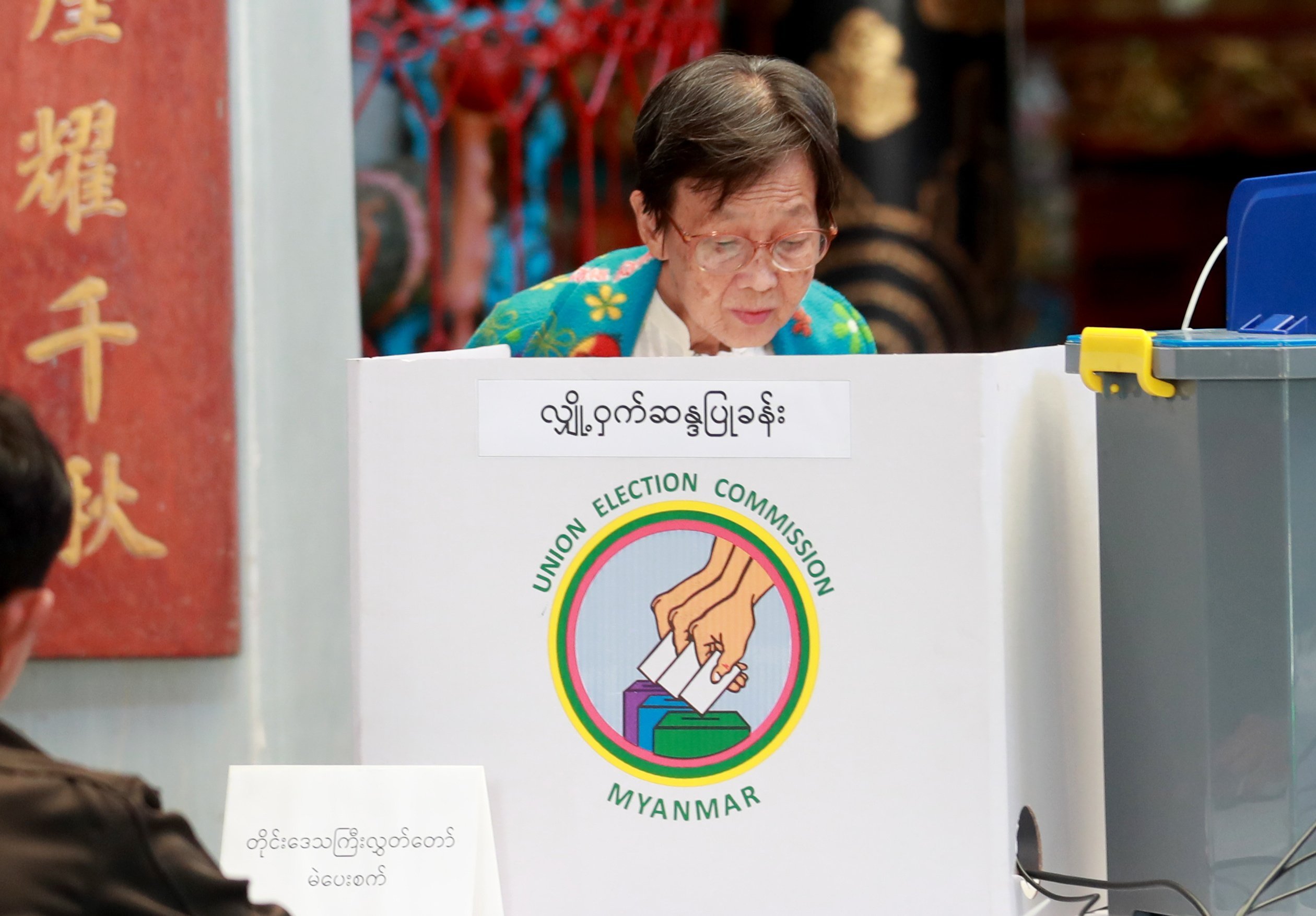 A woman casts a ballot during the second phase of Myanmar’s election in Yangon on Sunday. Photo: EPA