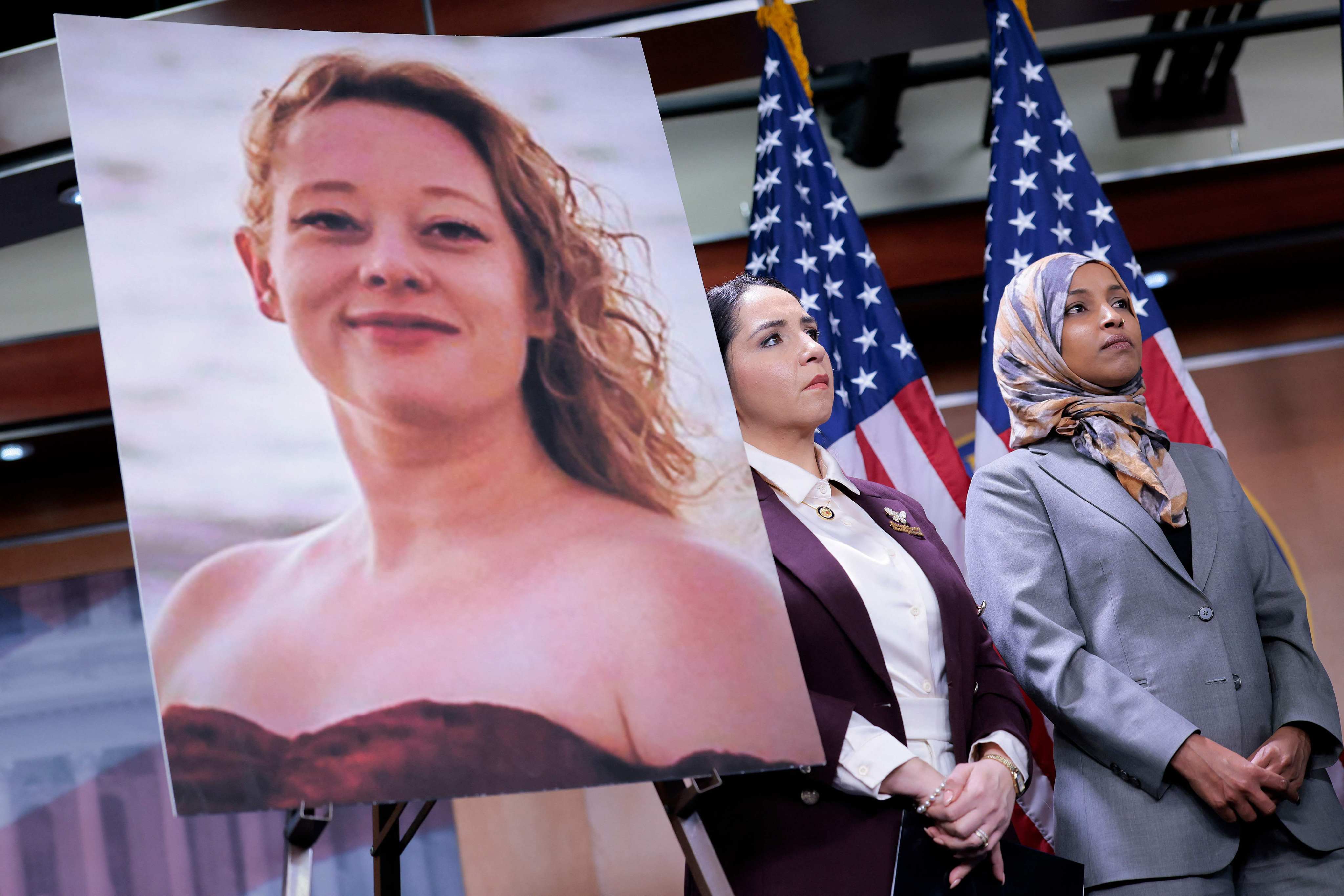 US congresswomen Ilhan Omar (right) and Delia Ramirez stand beside a portrait of Renee Nicole Good  at a press conference in Washington on Tuesday. Photo: AFP