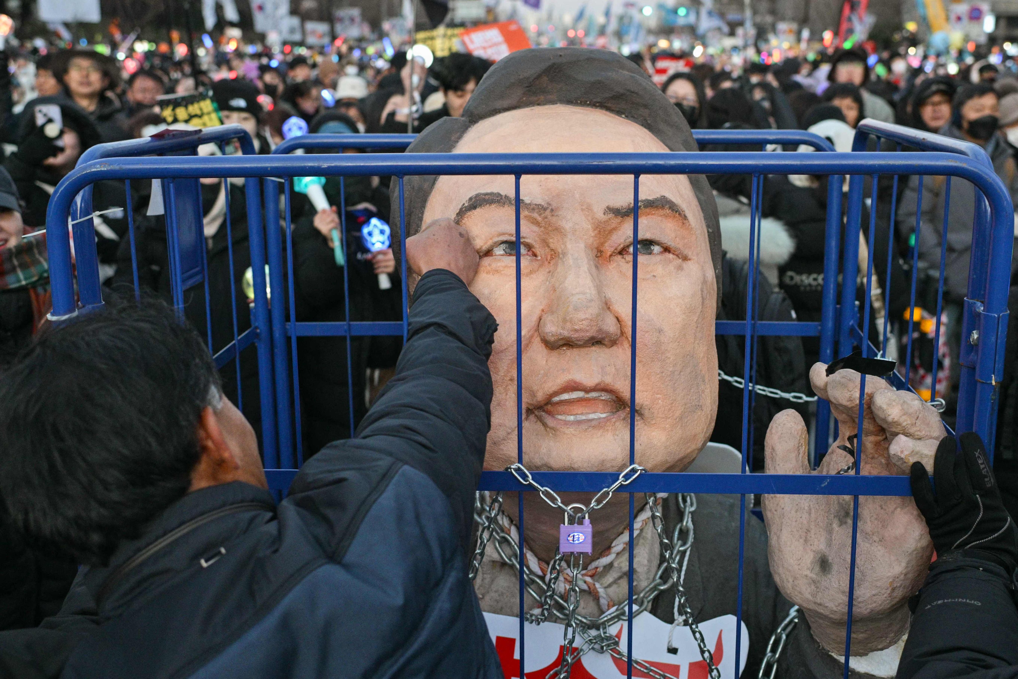 A protester punches an effigy of Yoon Suk-yeol outside the National Assembly in Seoul in 2024. Photo: AFP