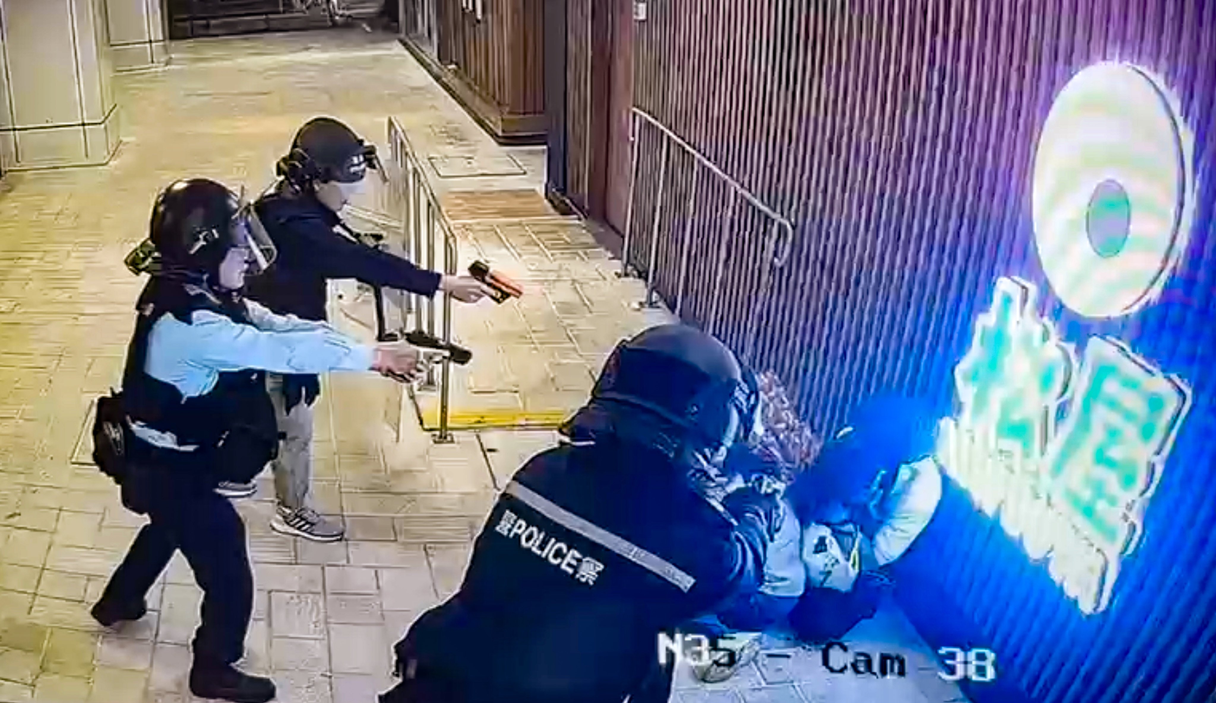 Police officers point their weapons at the man in Tuen Mun Town Plaza. Photo: handout