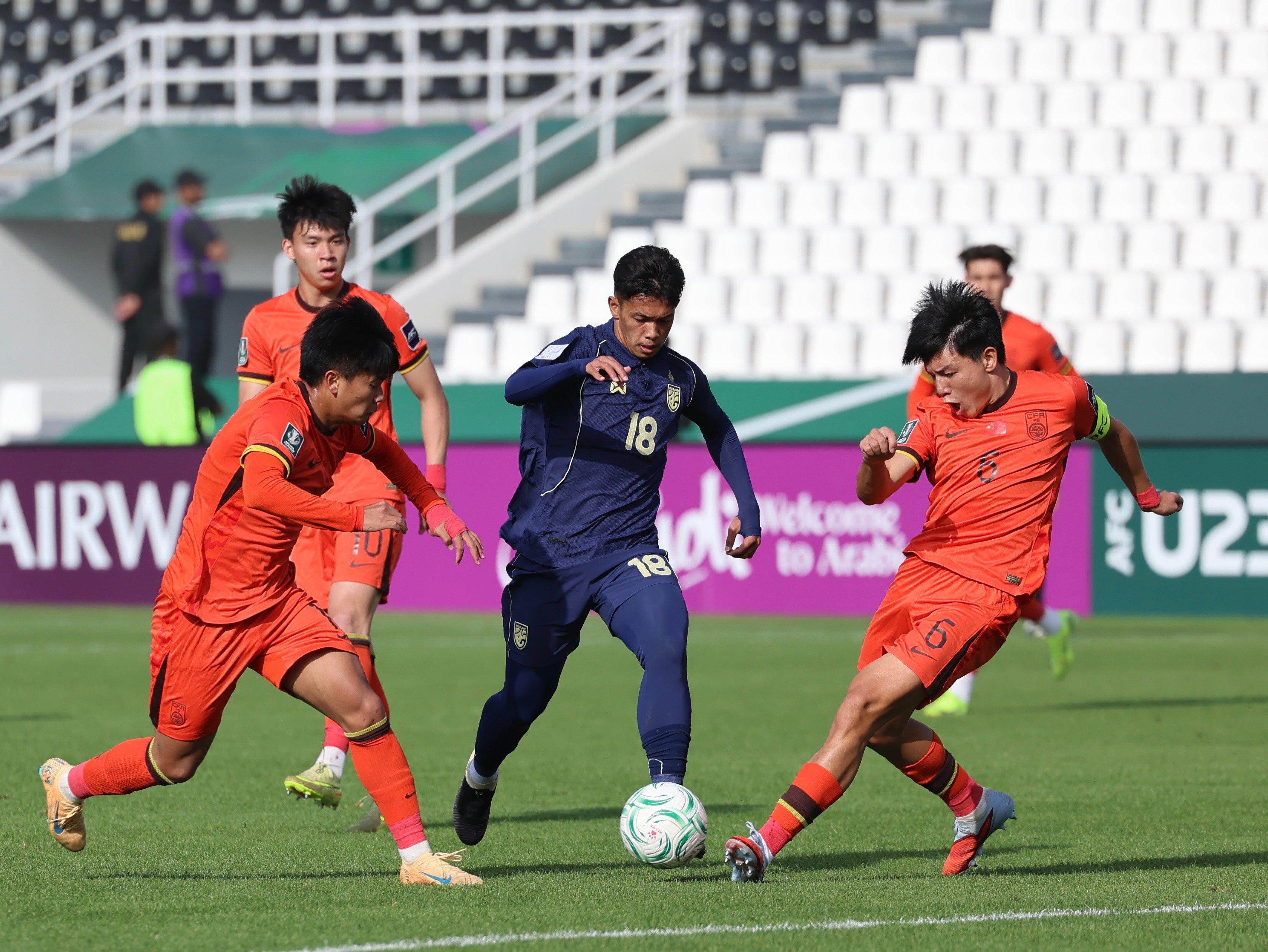 China’s under-23 football team (orange) finished second in their group at the AFC U-23 Asian Cup. Photo: Xinhua