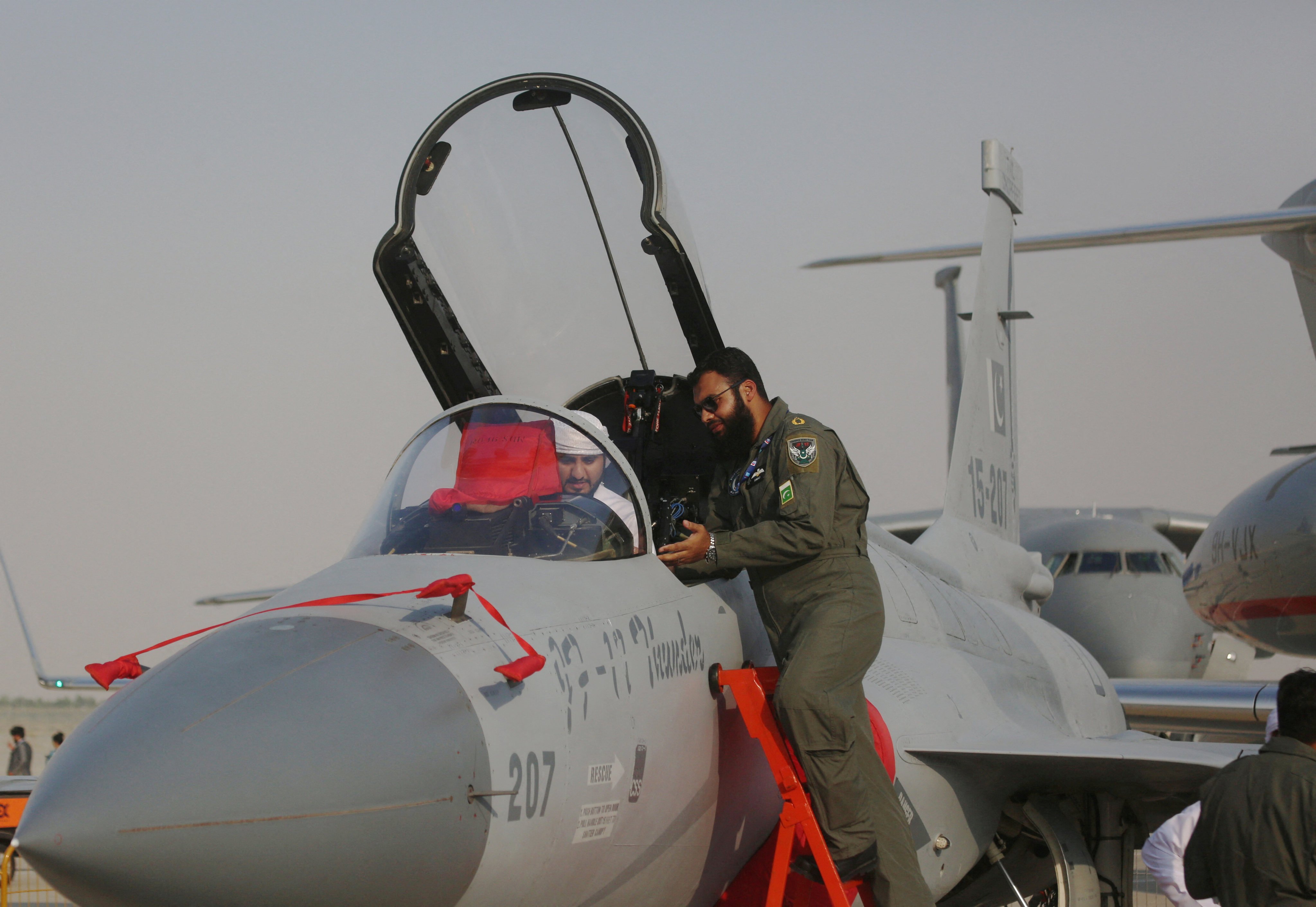 A visitor takes a look at a JF-17 jet fighter during an air show in Dubai in 2017. Photo: Reuters