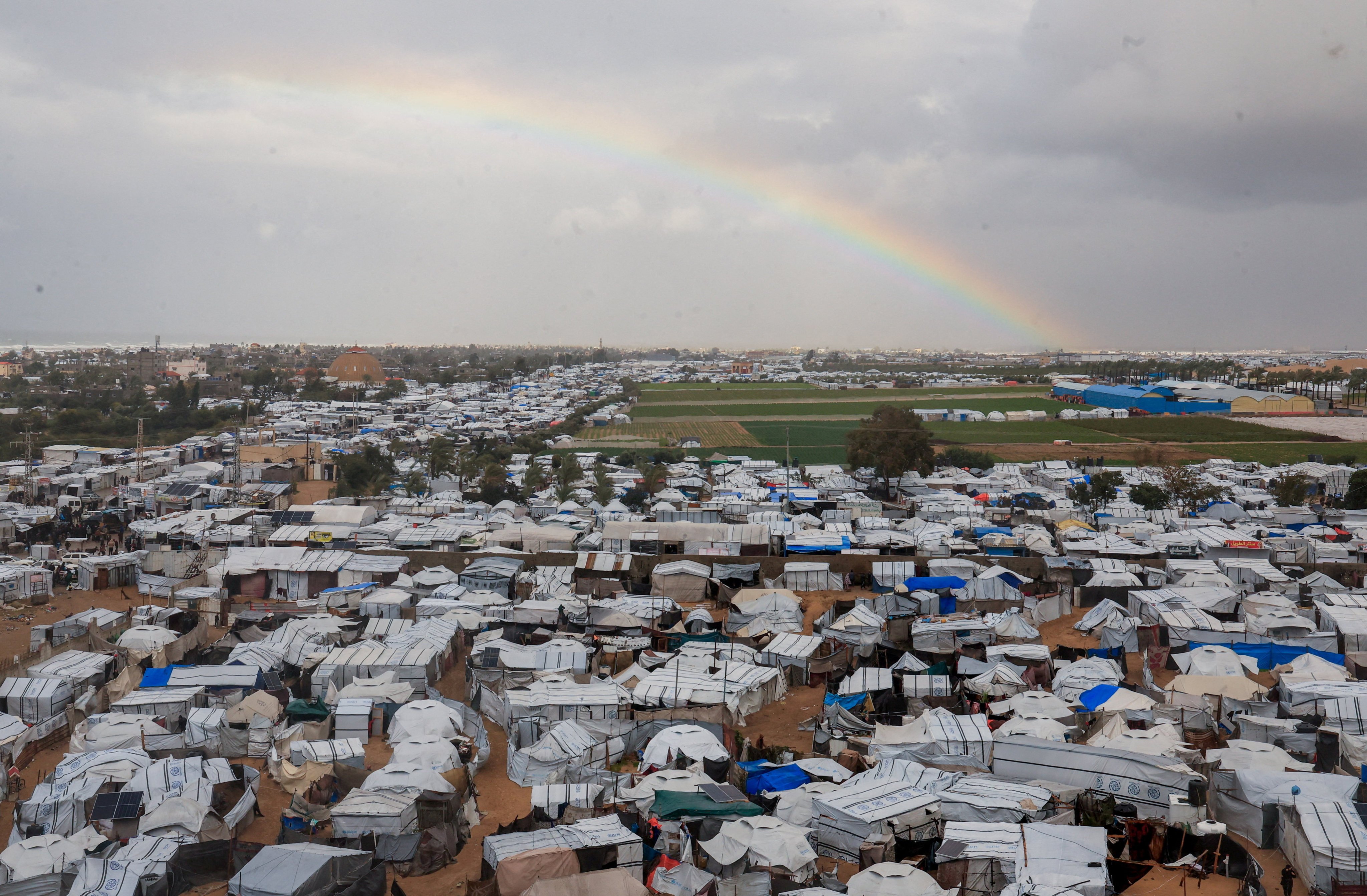 A rainbow appears over tents sheltering displaced Palestinians in Khan Younis, southern Gaza. Photo: Reuters