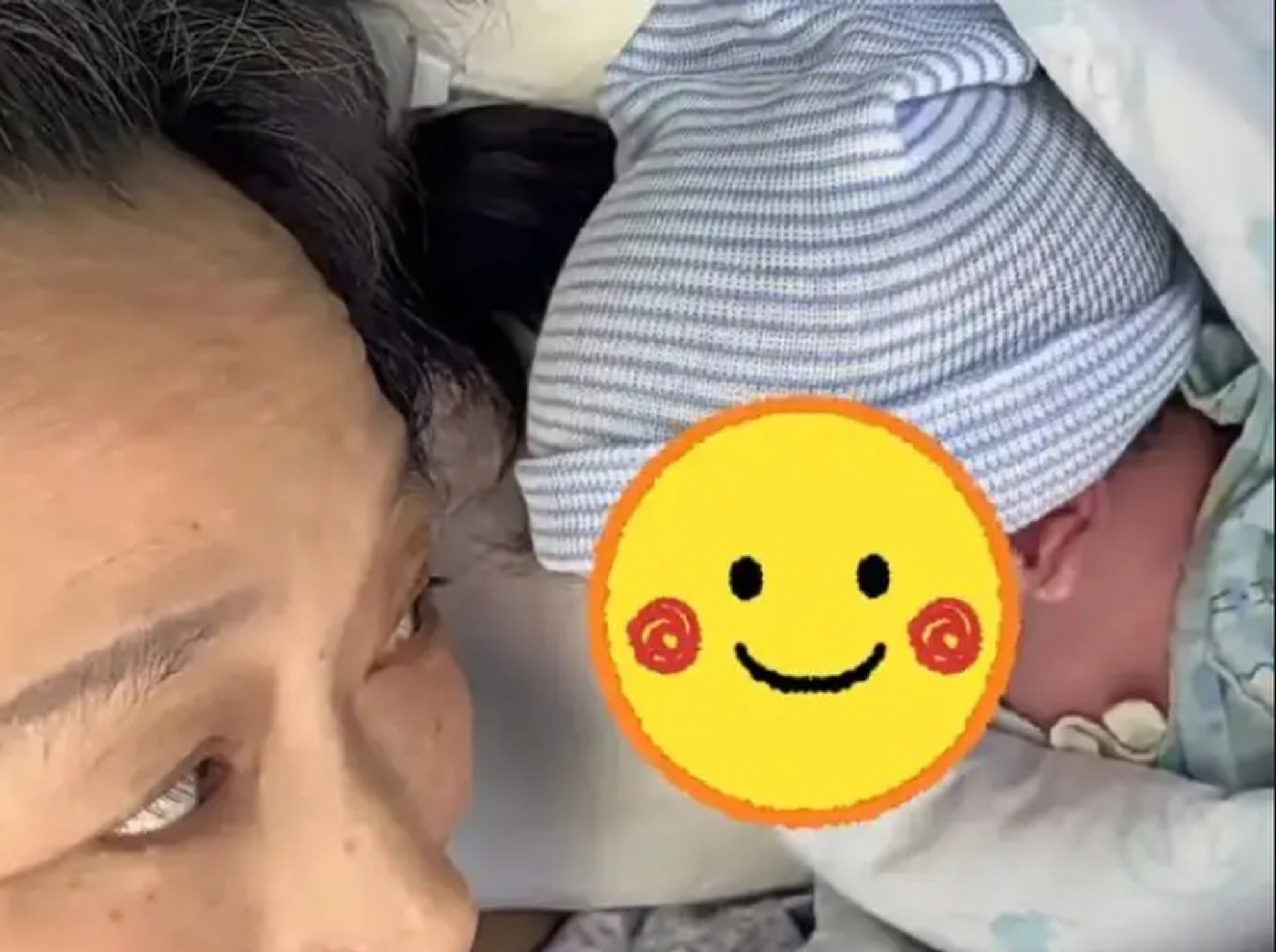 Bundle of joy: Zou looks lovingly at her newborn baby. His arrival made her the oldest woman in her home city to have given birth. Photo: Sohu