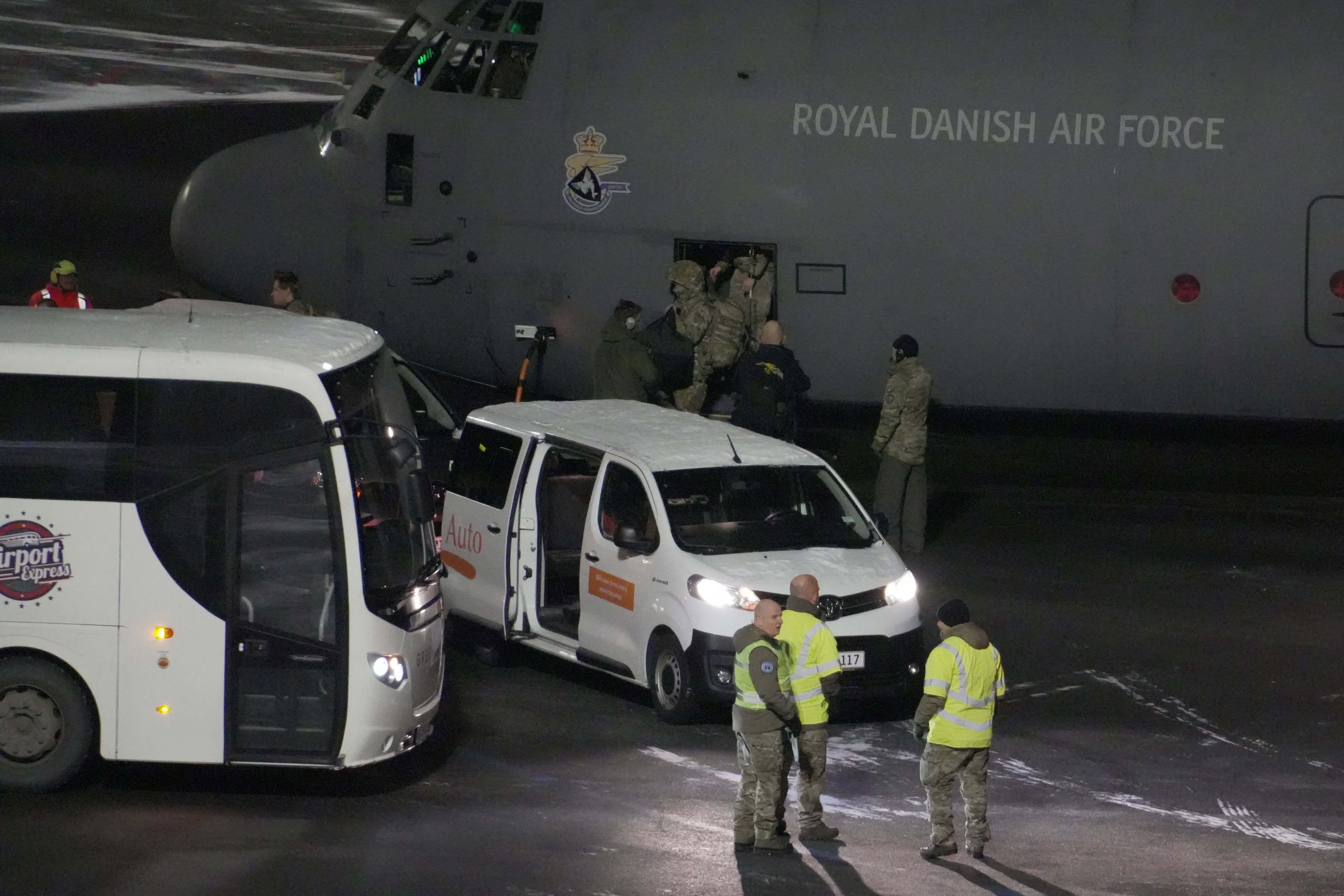 A Royal Danish Air Force plane carrying personnel in military fatigues after landing at Nuuk airport in Greenland. Photo: Reuters