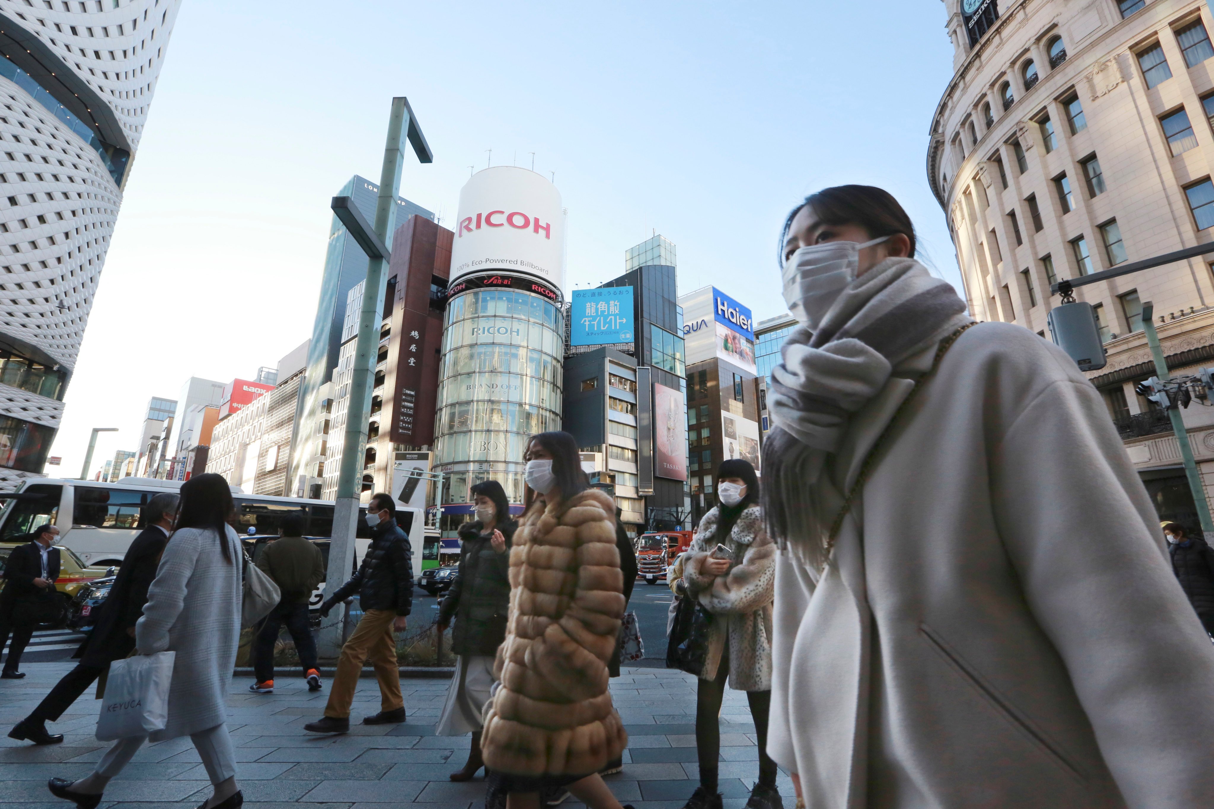 People wearing face masks walking on a street in Tokyo. Japan imports most of its antibiotics from China. Photo: AP