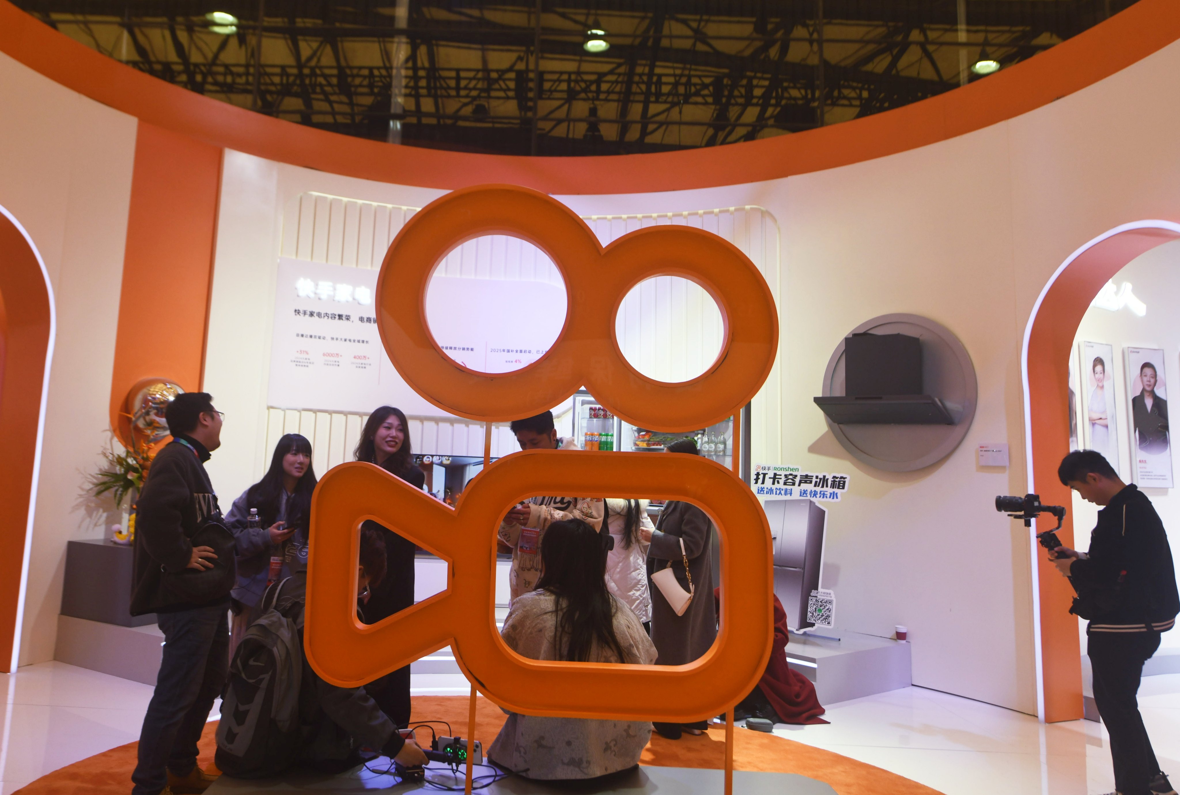 People visit a Kuaishou stand at an expo in Shanghai, China. Photo: Getty Images