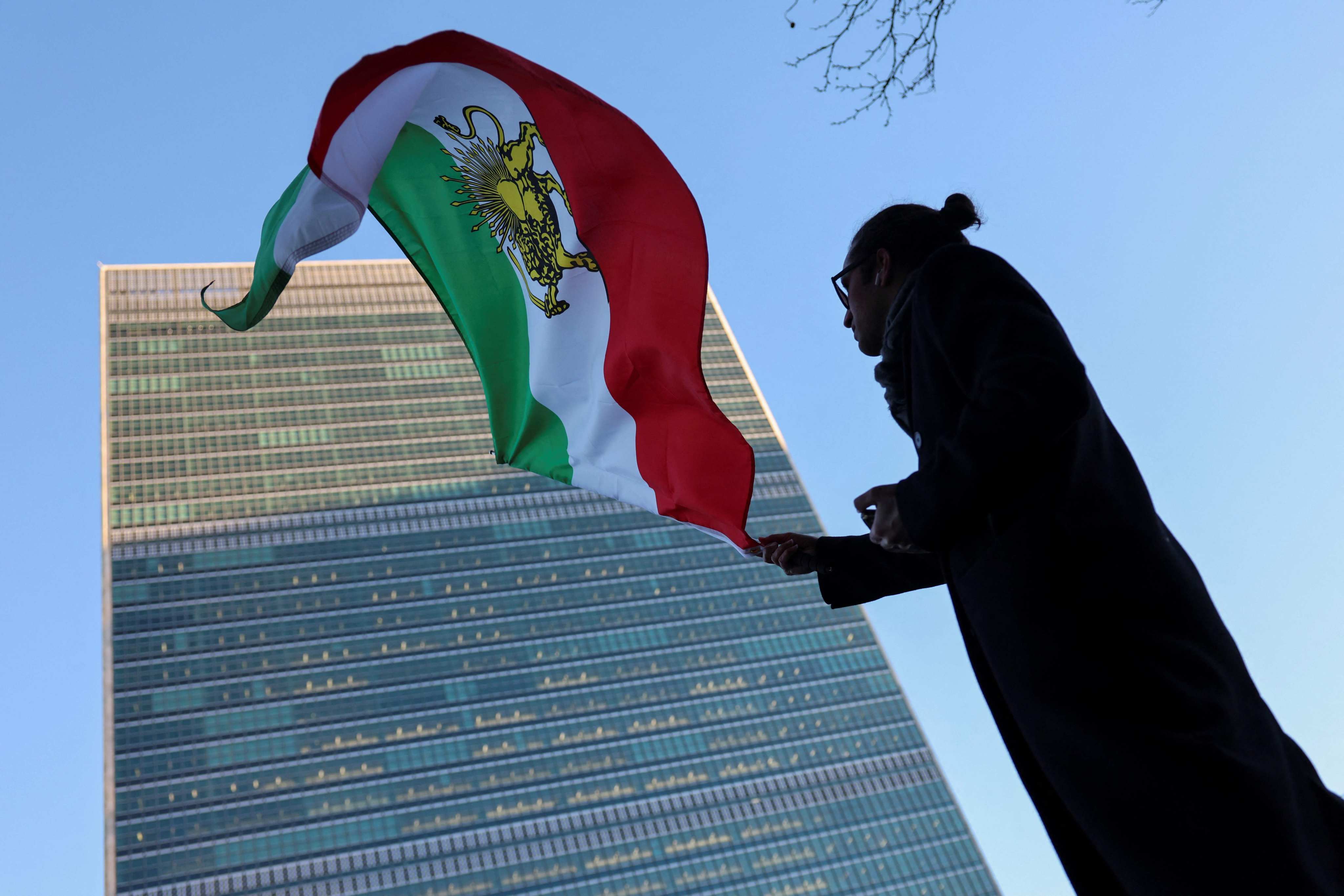 A protester waves the Iranian flag outside UN headquarters in New York during a Security Council meeting on Iran on Thursday. Photo: AFP