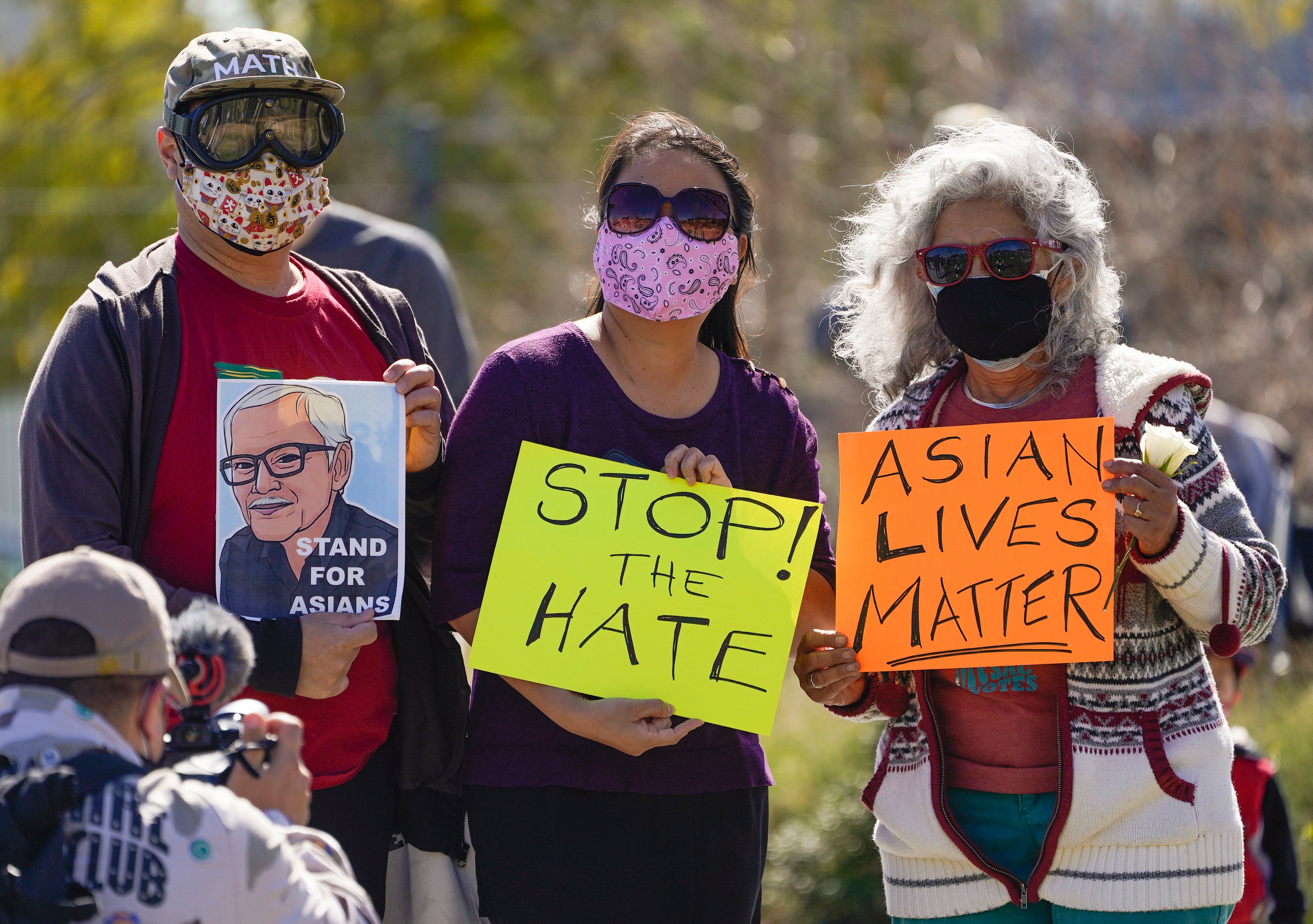 A man holds a portrait of Vichar Ratanapakdee during a rally in Los Angeles in February 2021. Photo: AP
