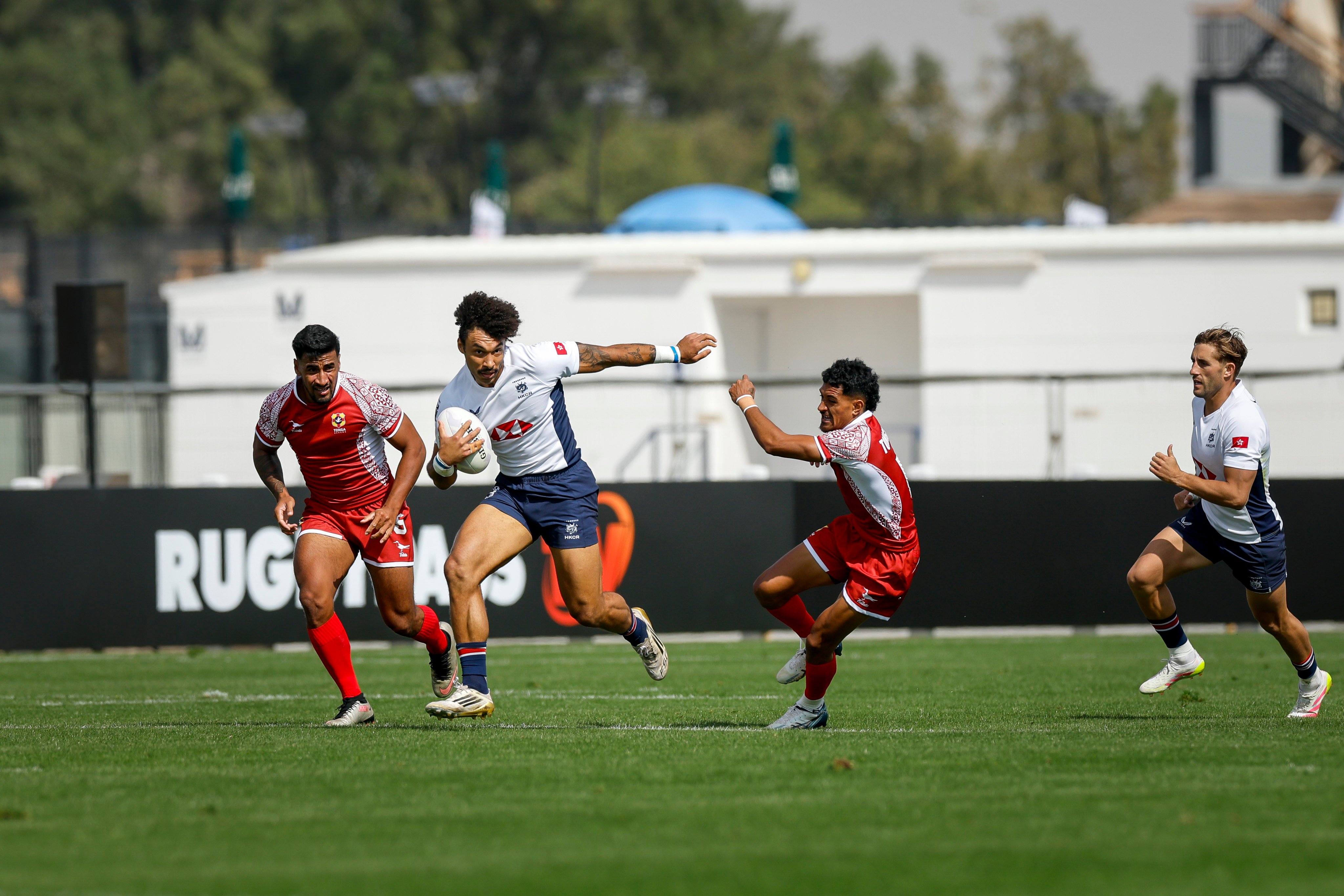 Max Denmark wriggles free of attention during Hong Kong’s victory over Tonga. Photo: World Rugby