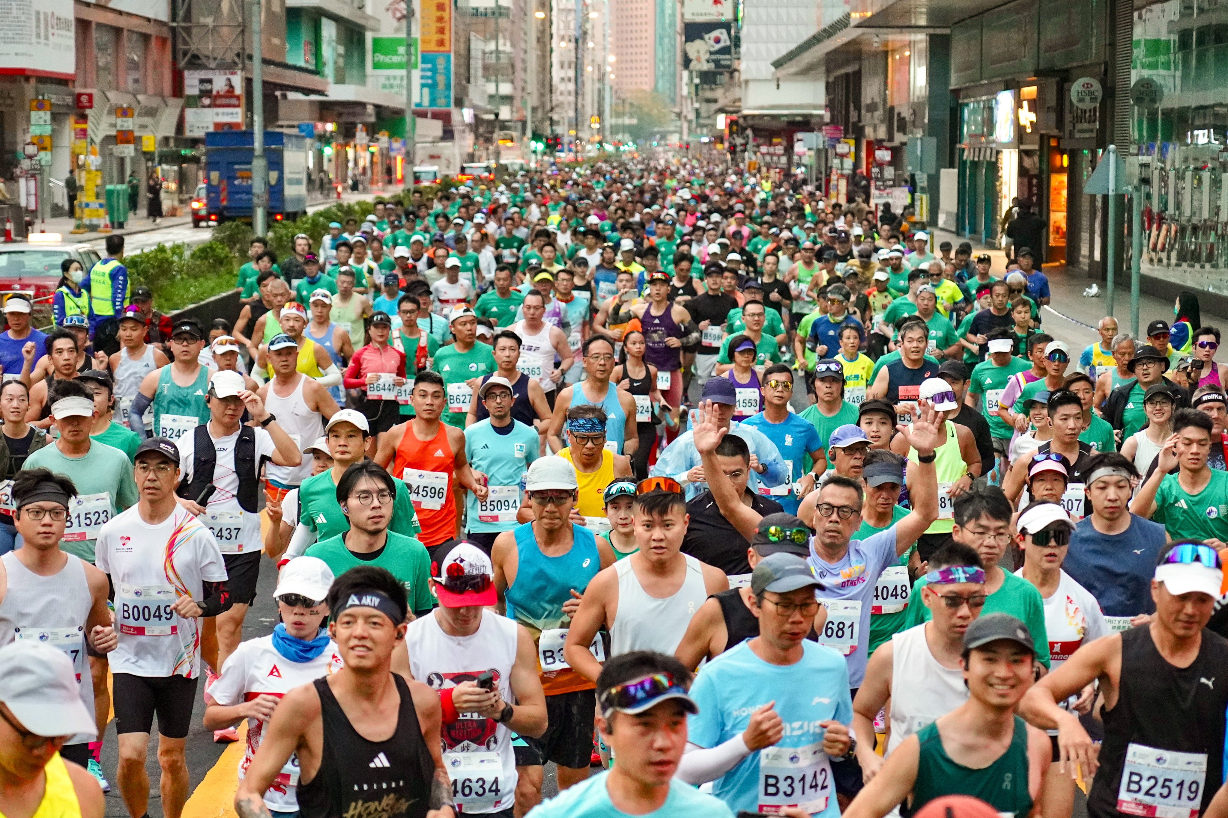 Runners in the Standard Chartered Hong Kong Marathon 2026 pass through Mong Kok along Nathan Road. Photo: Karma Lo
